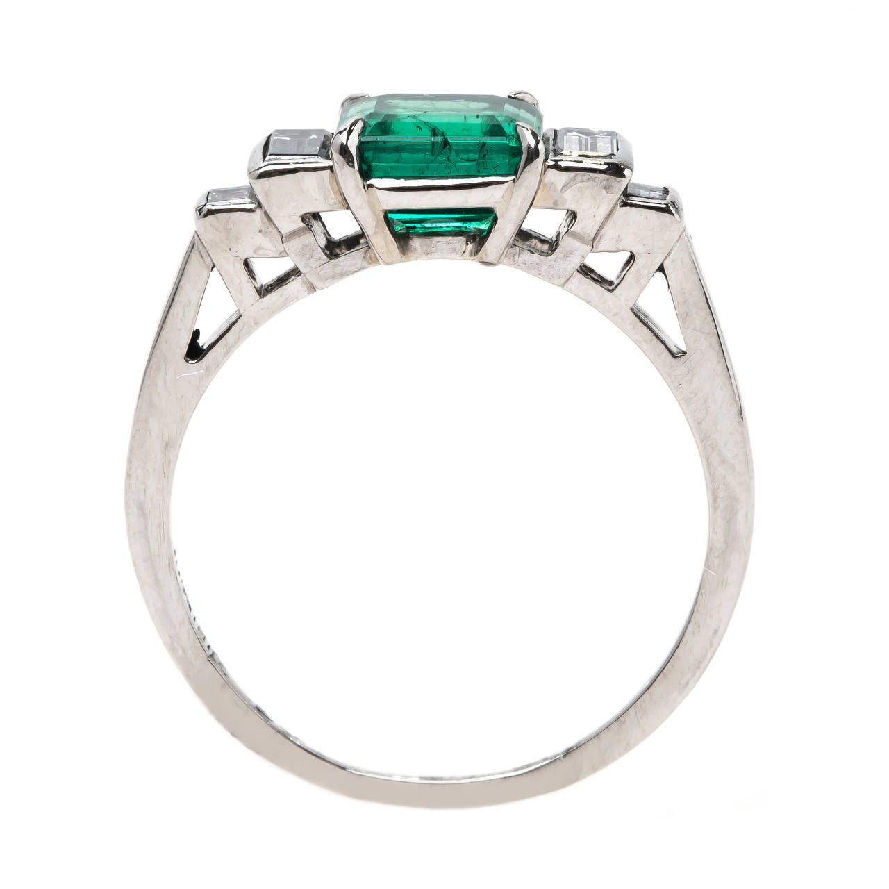 McKinney is a classic authentic Mid-Century (circa 1950) platinum-set emerald and diamond engagement ring featuring an unbelievable 1.08ct Step-Cut square emerald. This majestic emerald is accompanied by a Guild Laboratory certificate stating that
