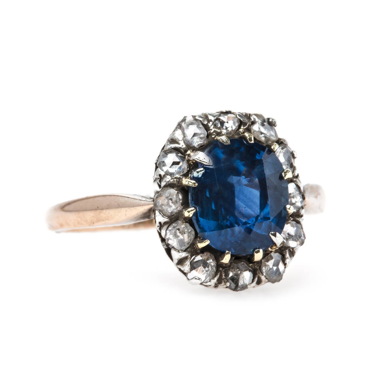 Oak Glen is a stunning authentic Victorian era (circa 1880) antique sapphire and diamond engagement ring made from silver topped 18k rose gold. This dignified ring features a natural oval sapphire gauged at 1.75cts accompanied with a Guild