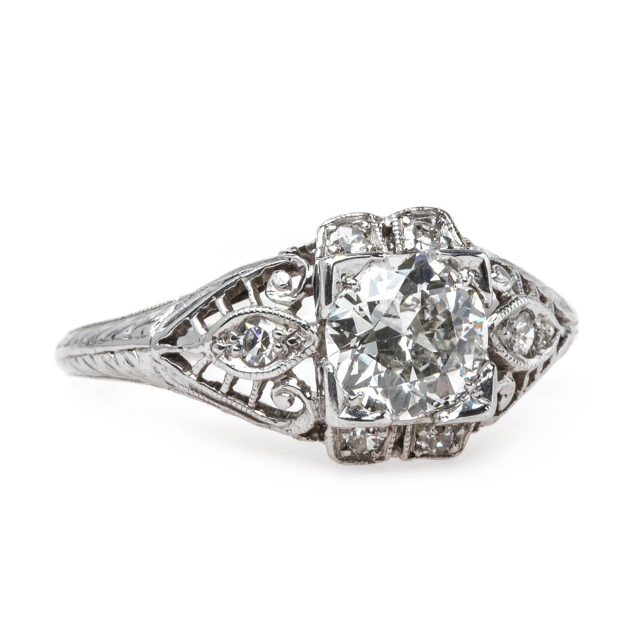 Captiva is truly a one-of-a-kind Edwardian era (circa 1915) platinum ring centering a box set 0.71ct EGL certified Old Mine Brilliant Cut diamond graded G color and SI1 clarity. This alluring ring is a statement of perfection and is further adorned