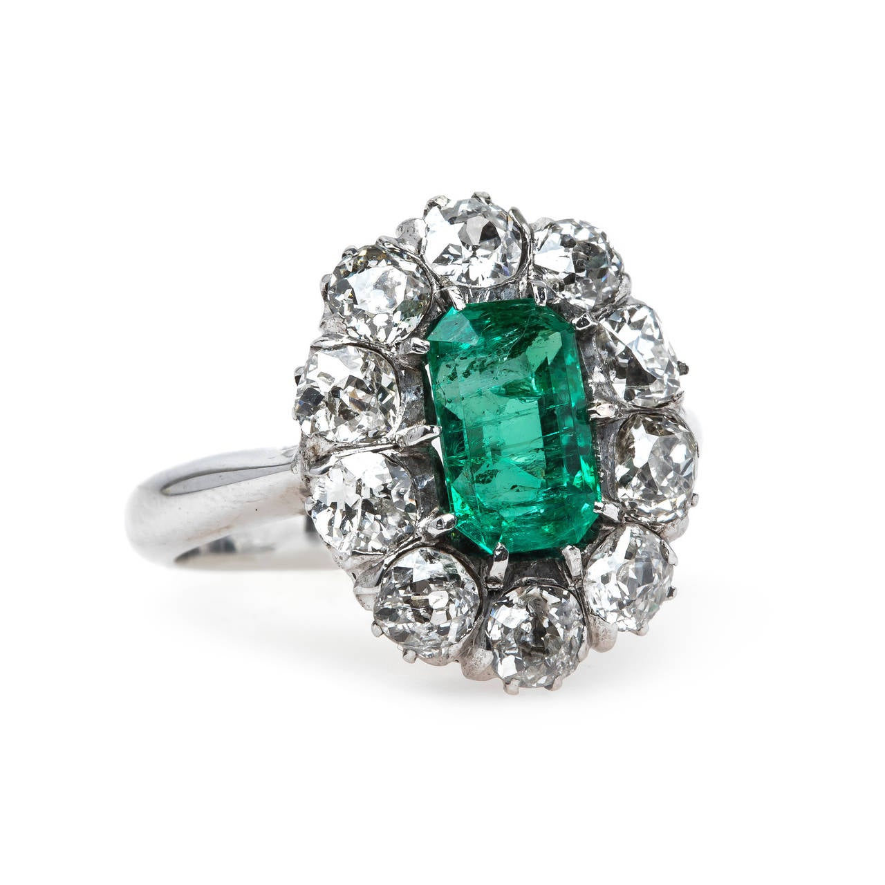Joshua Tree is a fantastic authentic Late Art Deco (circa 1930) 14k white gold cluster ring centering a luscious rectangular Step-Cut natural emerald, approximately 1.30ct accompanied with a Guild Laboratories certificate stating the emerald is