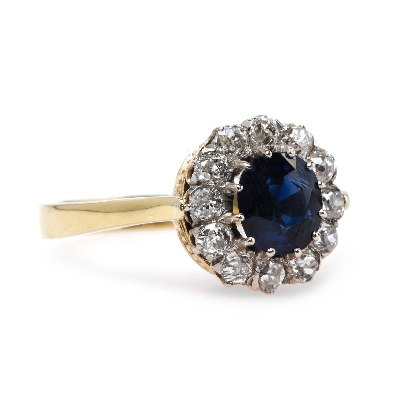Lone Hill is an impressive authentic Victorian era (circa 1885) sapphire and diamond engagement ring made from 18k yellow gold. This dignified ring features an unheated natural sapphire gauged at 1.20cts accompanied by a Guild Laboratories