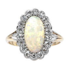 Antique Captivating Victorian Era Cabochon Opal Engagement Ring with Diamond Halo