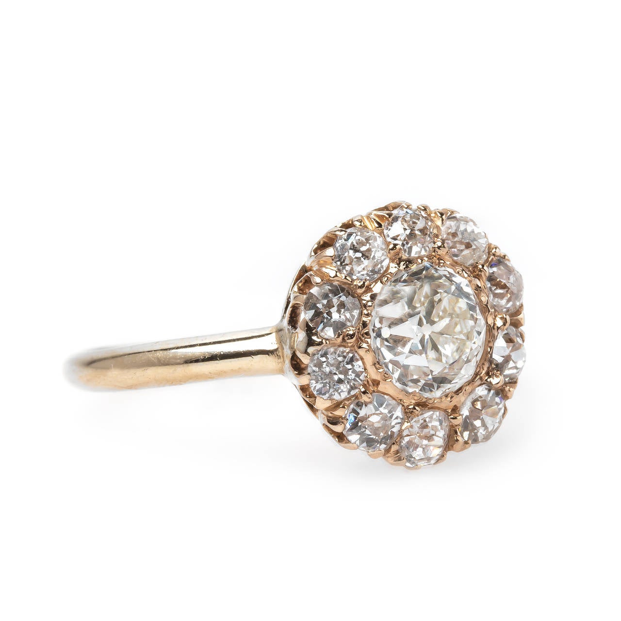 Beacon is a fabulous authentic Victorian era (circa 1890) 14k rose gold ring centering a sparkling 0.73ct EGL certified Old European Cut diamond graded G color and VS1 clarity. This high quality diamond is brilliantly framed by a halo of ten Old