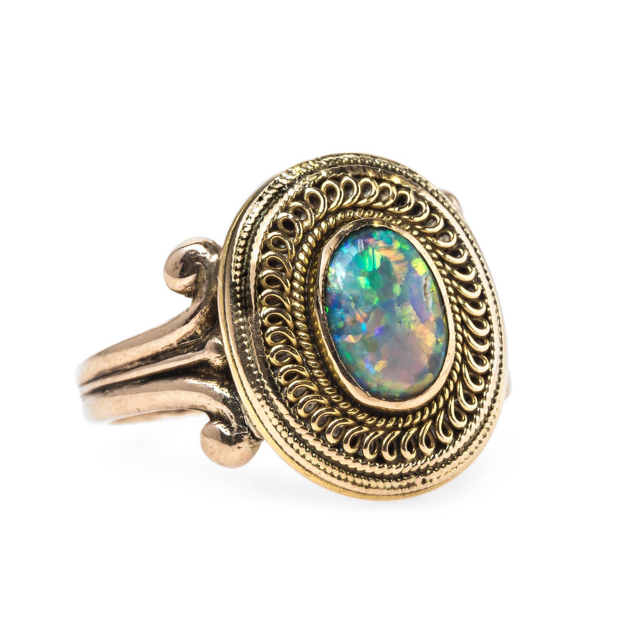 Cheyenne is a unique authentic Victorian era (circa 1900) 18k yellow gold and 14k yellow ring centering an incredible bezel set black cabochon oval opal gauged at 8mm x 6mm displaying an array of rainbow play-of-color. Cheyenne is further surrounded