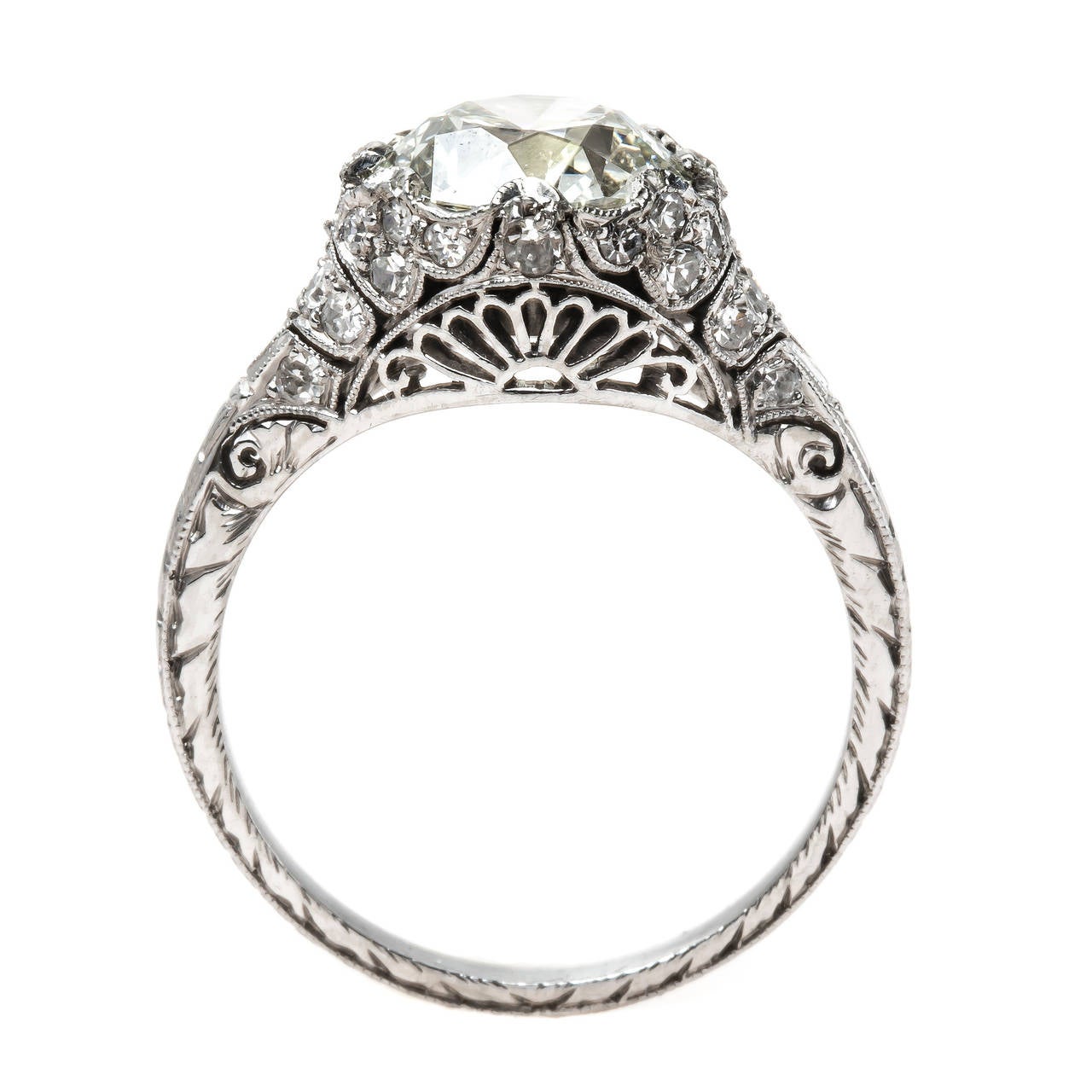 Carlton is an over-the-top authentic Edwardian era (circa 1910) platinum ring centering a stunning 2.77ct EGL certified Transitional Brilliant Cut diamond graded K color and VS2 clarity. This one-of-a-kind ring is further adorned with thirty-two