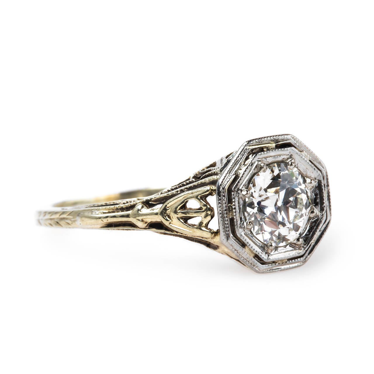 Dorchester is a romantic and beautifully detailed Edwardian era (circa 1905) ring made from 14k white and yellow gold centering a 0.69ct EGL certified Old European Cut diamond graded H color and VS2 clarity. This delightful antique diamond is set