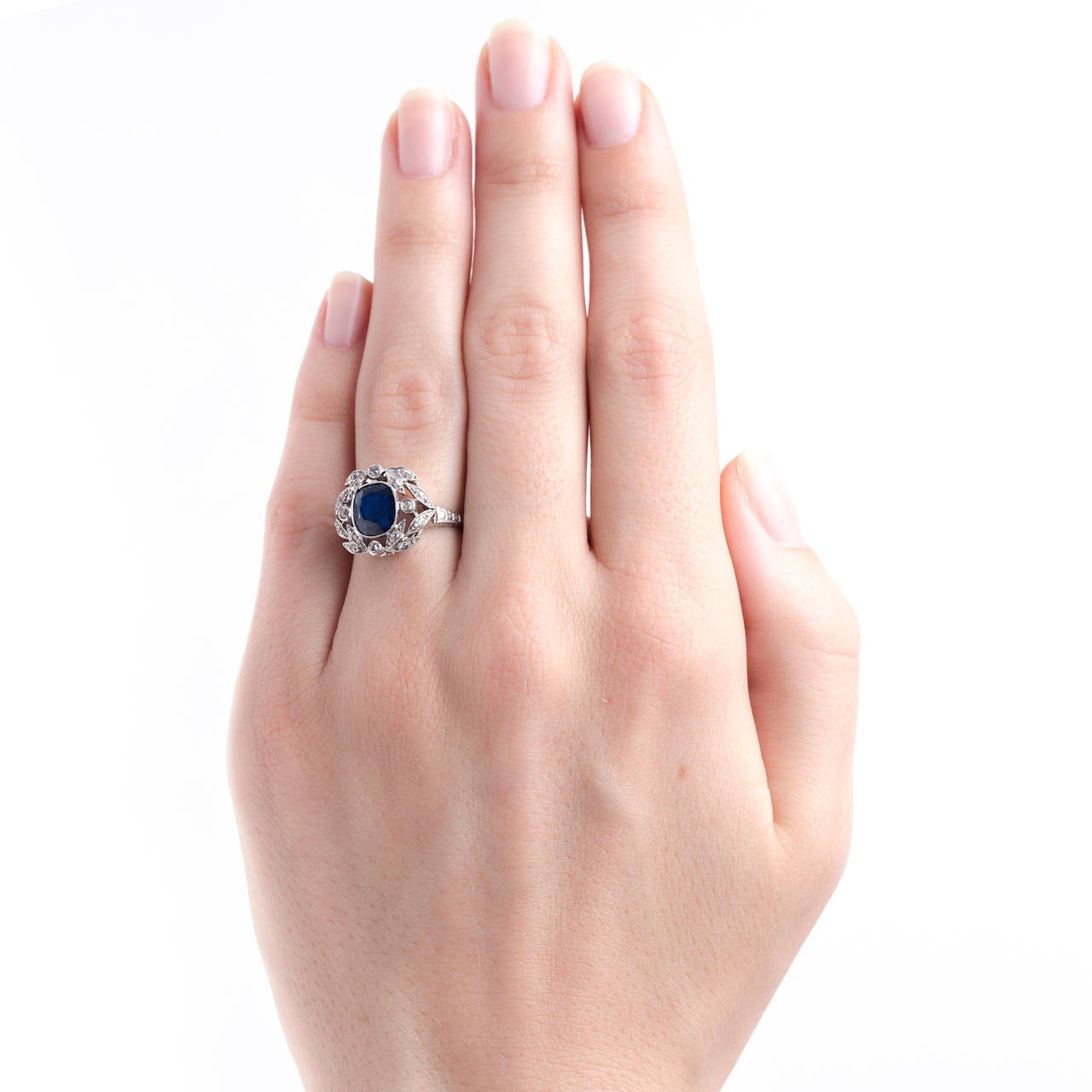 Bonaparte is a magnificent Edwardian era (circa 1915) platinum ring centering a beautiful bezel set 2.40ct Cushion cut sapphire accompanied with a GIA certificate stating the sapphire is unheated. Bonaparte is further designed with a delicate and