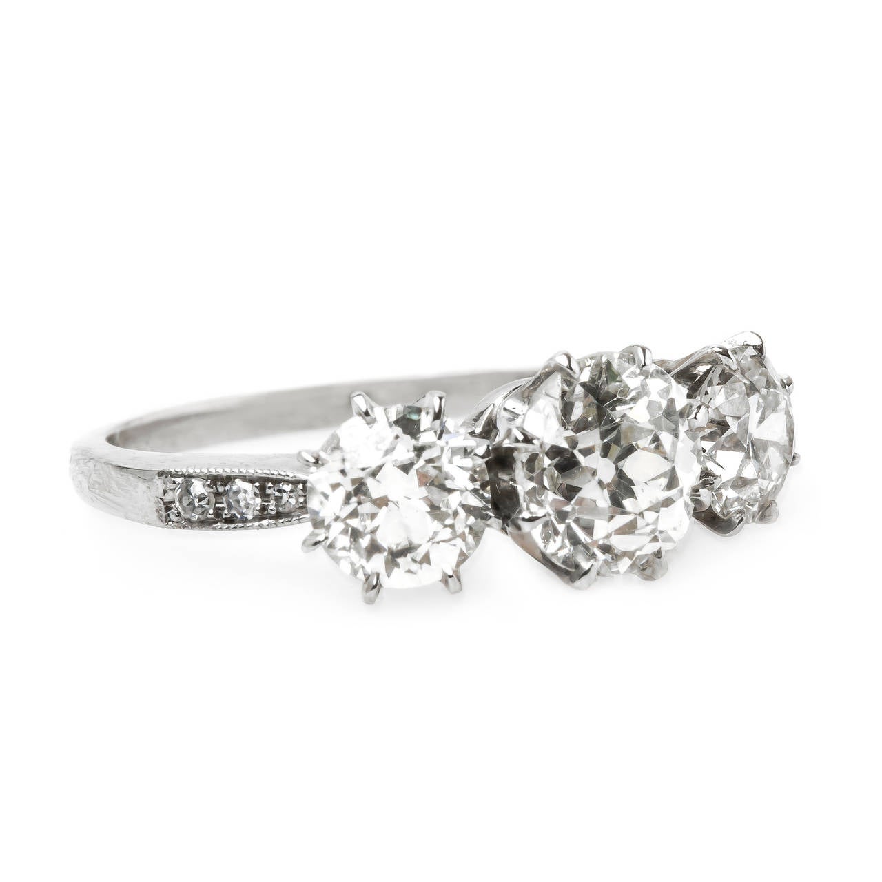 Bedford is stunning Trumpet & Horn original vintage-inspired ring featuring a dazzling three-stone diamond combination. The Platinum ring centers an eight-prong 1.20ct EGL certified Old Mine Cut diamond graded K color and VS2 clarity. The center