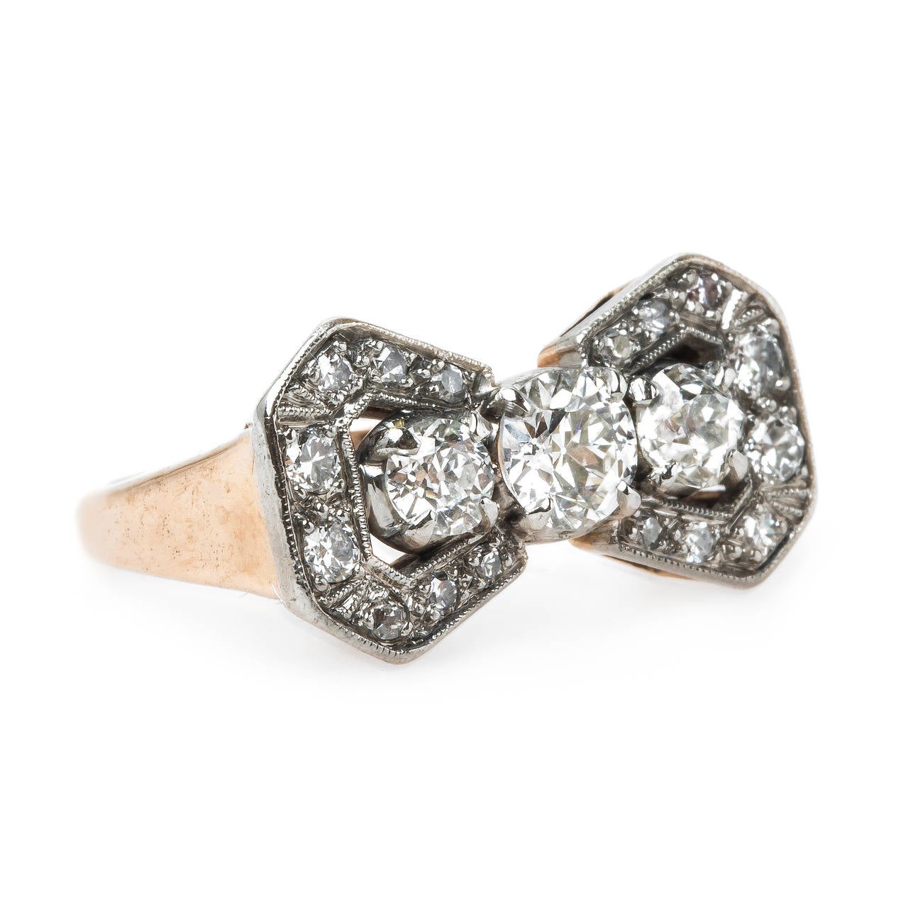 Windrose Way is complimentary authentic Retro era (circa 1940) platinum topped 14k rose gold ring designed in the shape of an exquisite bow. The ring centers a four-prong set 0.44ct EGL certified Old European Cut diamond graded E color and SI1
