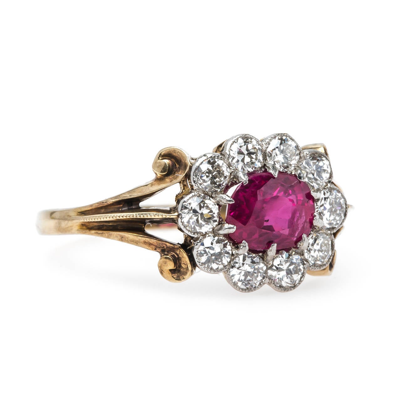 Orchard Park is a spectacular Edwardian era (circa 1910) platinum-topped 14k yellow gold ring complete with a T&H custom 14k yellow gold shank. The ring centers a ten-prong set oval natural ruby accompanied with a Guild Laboratories certificate