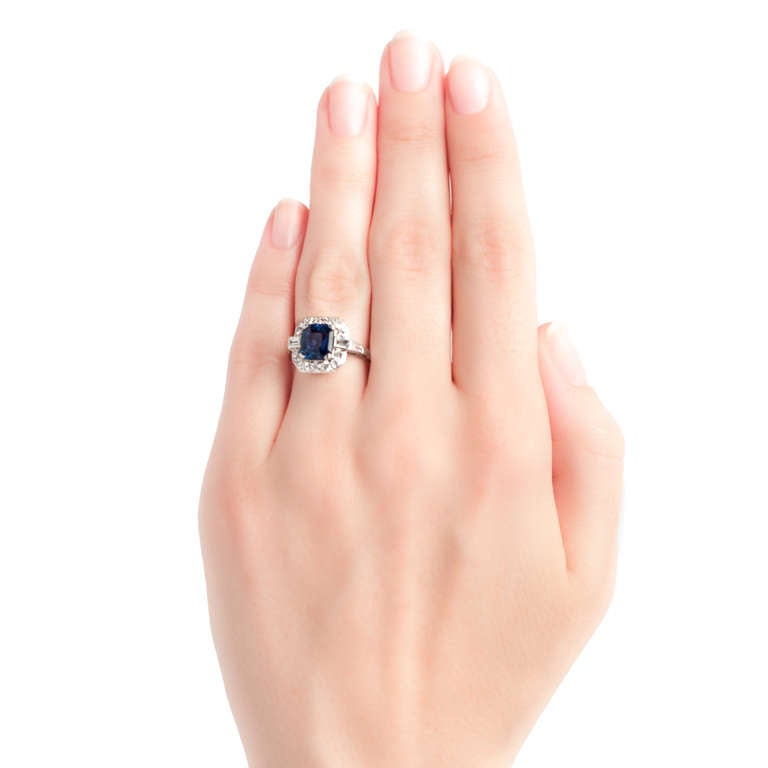 Shadow Creek is a sophisticated Art Deco platinum ring centering a natural square step cut sapphire gauged at 2.35cts and accompanied with a Guild Laboratories Certificate stating the sapphire is of Thailand origin and heat treated. The slightly