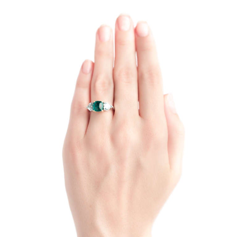 Mint Julep is a stunning modern Circa 1980 ring made from platinum and 18k yellow gold, featuring a unique bright green sugarloaf cabochon emerald gauged at 2.60cts accompanied with a Guild Laboratories  certificate stating the emerald has color and