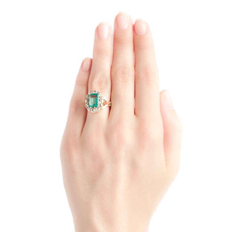 Clover Creek is a gorgeous Victorian Era 18k yellow gold cocktail ring centering a beautiful step cut emerald gauged at 2.50cts accompanied with a Guild Laboratories certificate stating the emerald is of Colombian origin. This pale yet  luxurious