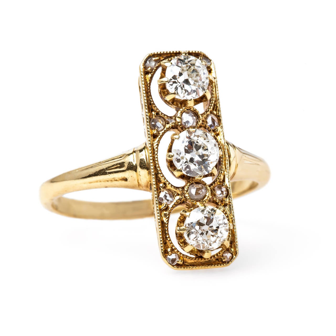 Abbey Road is a one-of-a-kind Victorian (circa 1895) 18k yellow gold ring centering three Old Mine Cut diamonds set vertically in a unique rectangular setting totaling approximately 0.60ct. The ring is further designed with ten Rose Cut diamonds