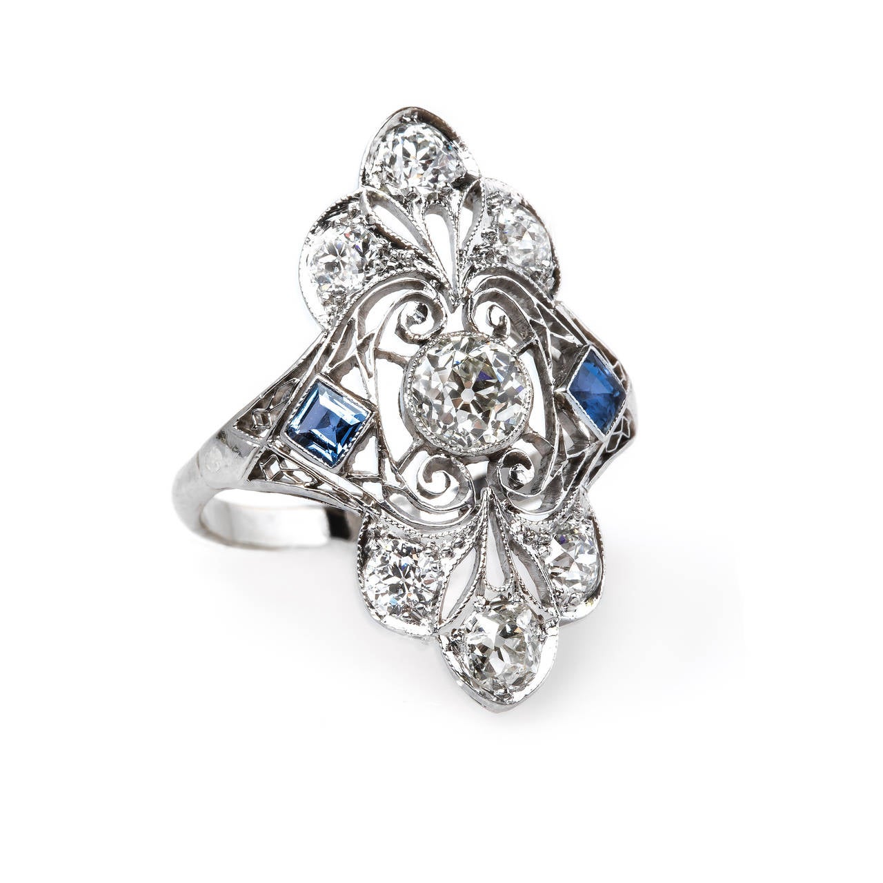 Pacific Grove is an ornate Edwardian era (circa 1915) platinum and 14k white gold ring centering a stunning bezel set 0.53ct EGL certified Old European Cut diamond graded K color and VS1 clarity. This beautifully crafted navette style ring is