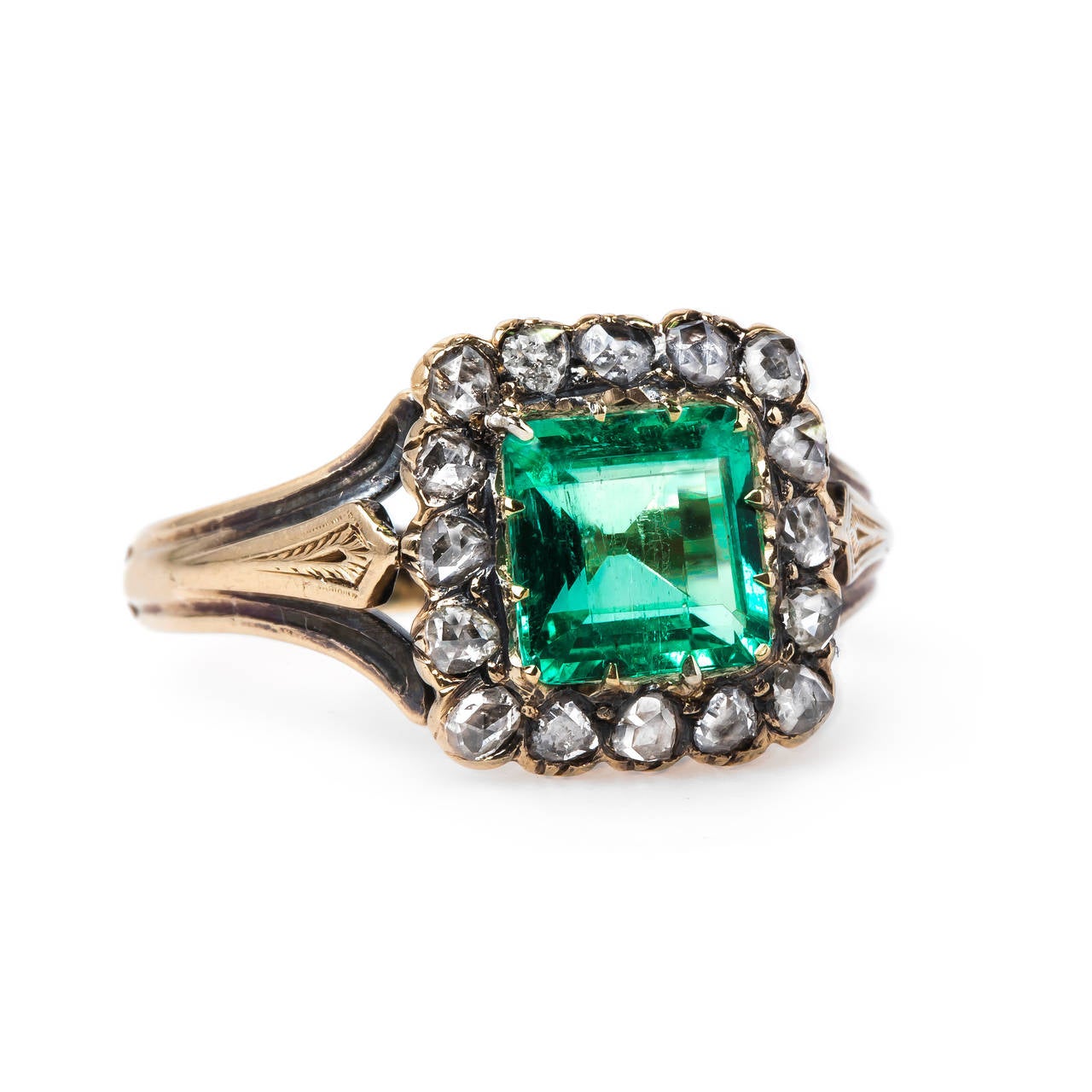 Greenwich is fabulous, one-of-a-kind Victorian era (circa 1895) 18k yellow gold ring featuring the extremely coveted French Hallmarks on the inside shank. Centering a 1.11ct Guild Laboratories certified Square Step-Cut Colombian emerald, the ring is