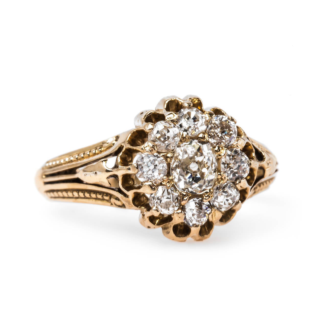 Penfield is an intriguing authentic Victorian era (circa 1880) 18k yellow gold featuring a sparkling cluster of nine Old Mine Cushion and Old Mine Cut diamonds totaling approximately 0.85ct. graded J-K color and SI clarity. Penfield is further