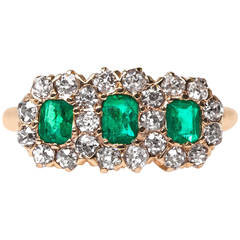 Late Victorian Three Stone Emerald Ring with Diamond Halo