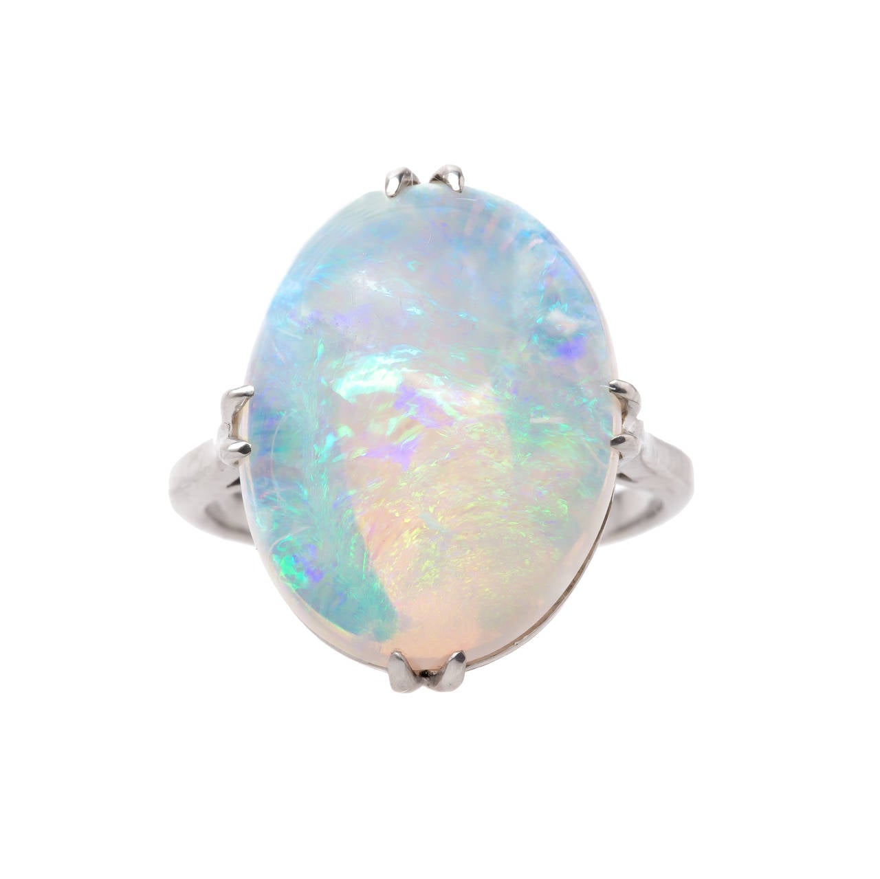 White Chapel. This Edwardian era opal ring is made from platinum and features a stunning oval opal certified by Guild lab0ratories.  This gorgeous natural white opal flashes dramatically with rainbow play of color and is set in an elegant hand made