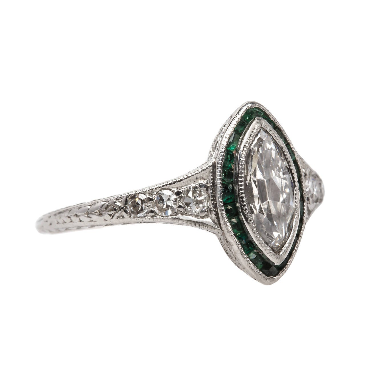 Avery is an authentic unique platinum Art Deco (Circa 1920) ring featuring a bezel set antique cut Marquise diamond weighing exactly 0.38 carat graded F-G color and SI2 clarity. Avery is further decorated with a halo of twenty-one calibre cut