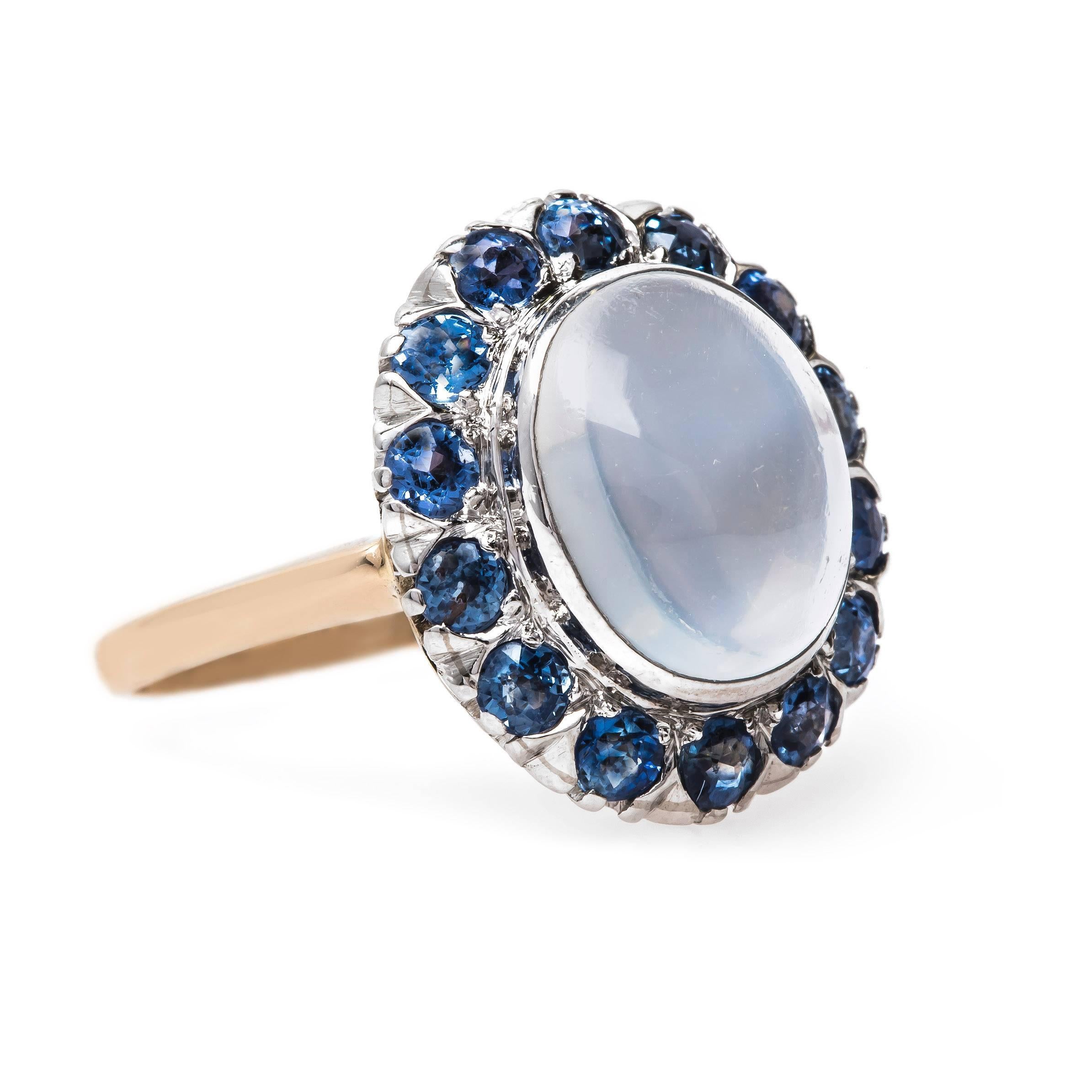 Floriston is an unforgettable Late Art Deco (circa 1935) cocktail ring sure to impress! This one-of-a-kind ring is made from platinum and 14k yellow gold centering a dreamy bezel set Oval Cabochon moonstone gauged at 12mm x 10mm with a weight of