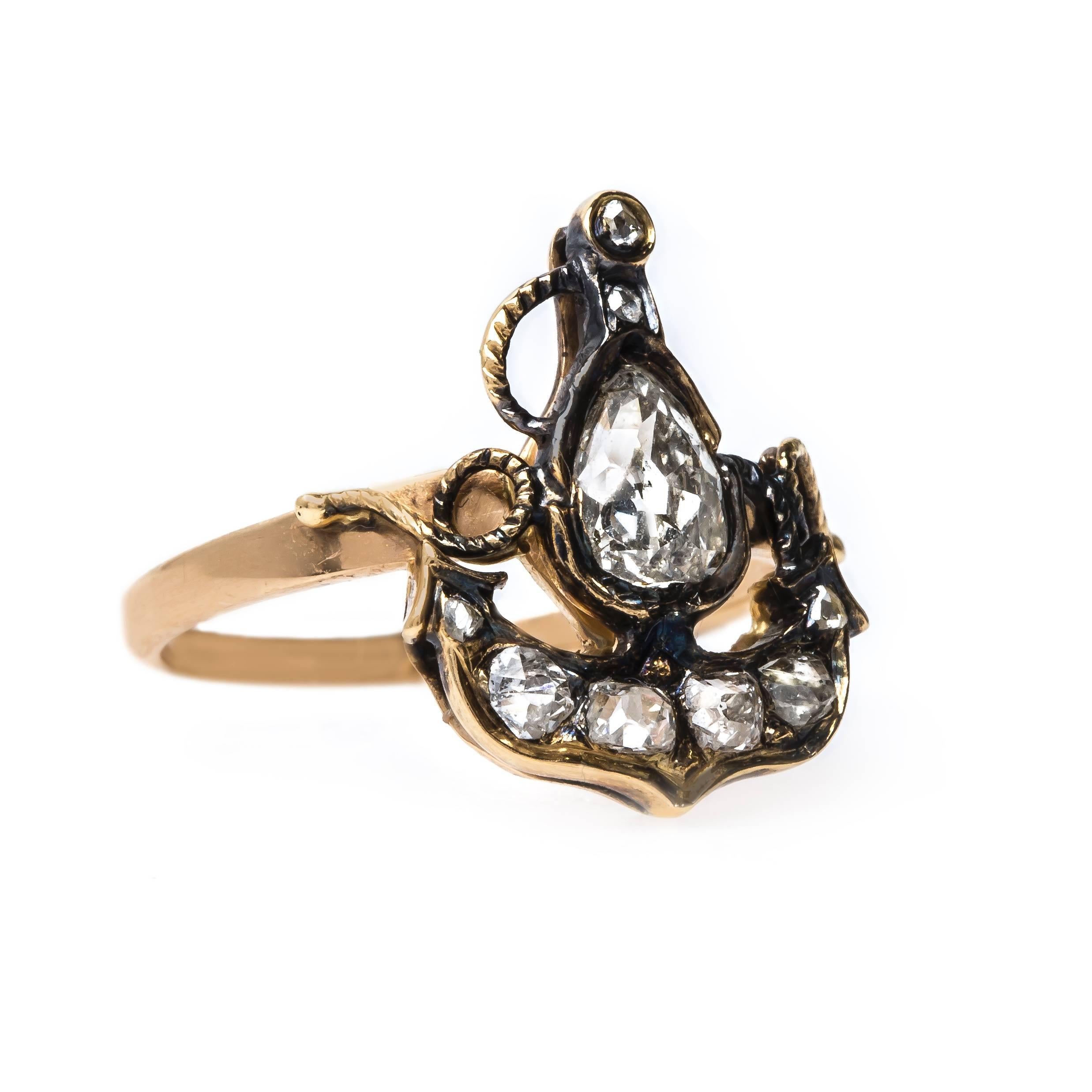 Cunningham is an incredible and authentic Victorian era (circa 1870) 18k yellow gold ring that started its life as an antique stick pin in the shape of an anchor. The nautical themed ring centers a bezel set antique Pear Cut diamond totaling