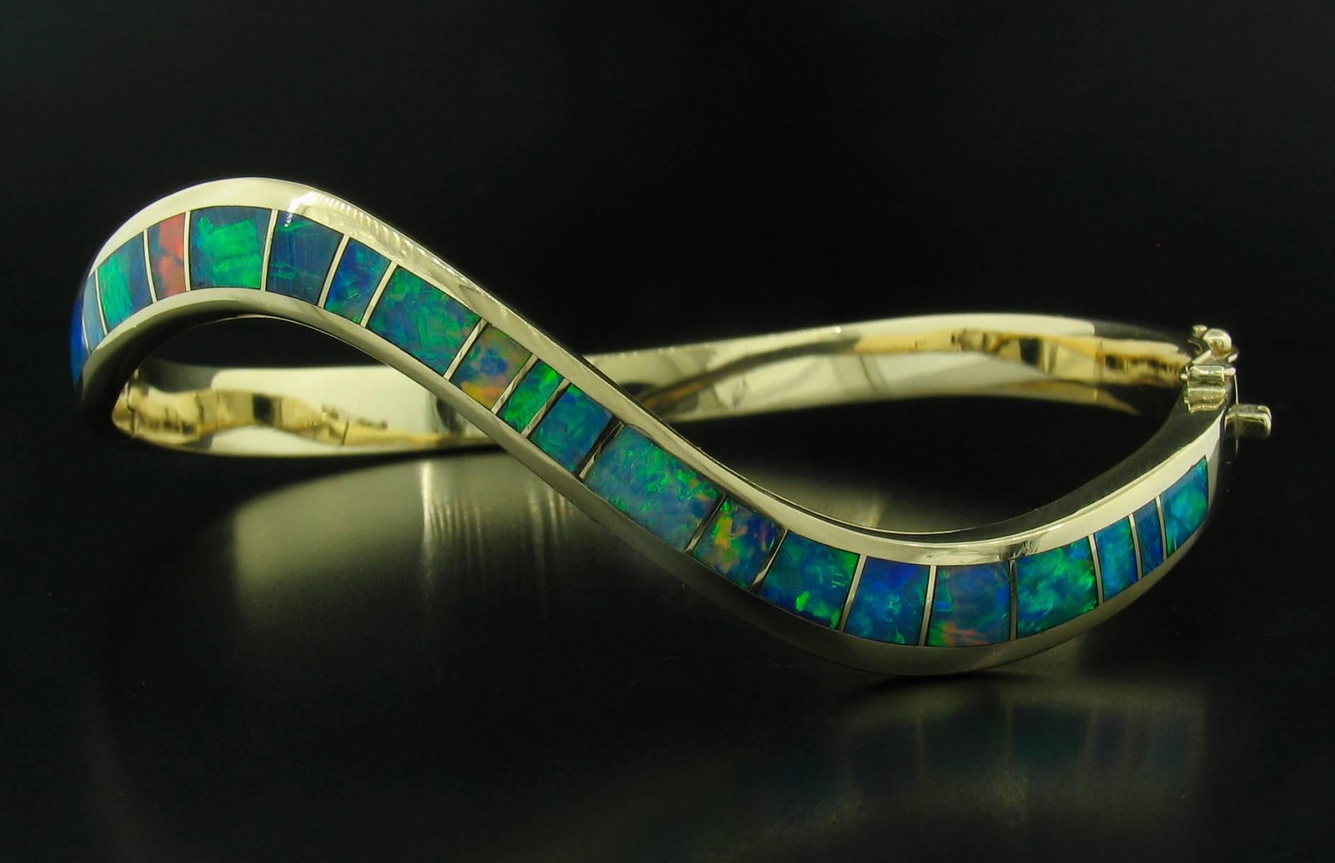Opal inlay hinged bracelet in 14k yellow gold, made by Mark Hileman, signed 'MMH'.  It measures 2 1/2"W X 2"D X 13/16".  Regular price $4,000