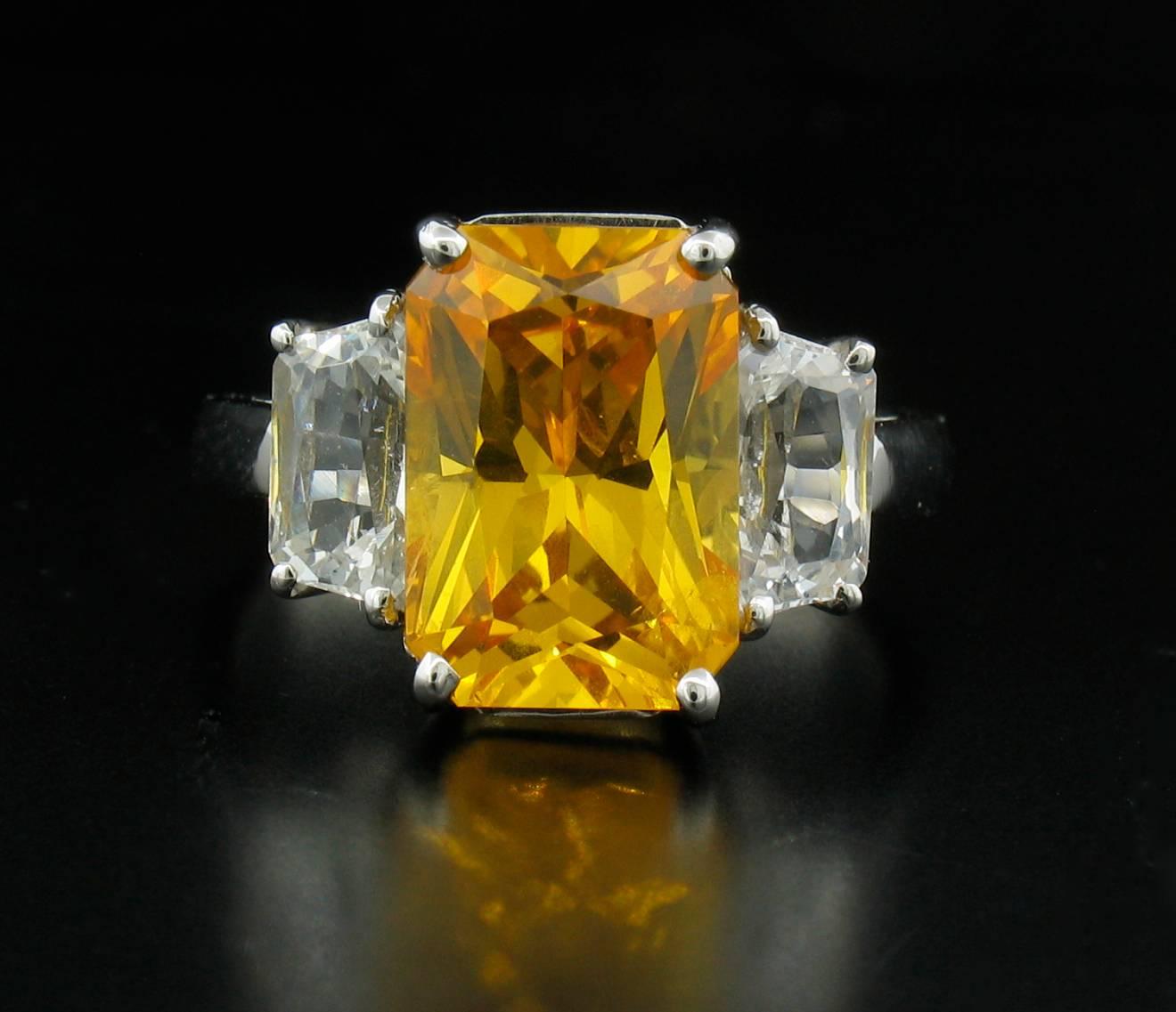 This stunning yellow sapphire weights 5.25 carats and is accented by fully faceted white sapphires weighing a total of 2.21 carats in a platinum setting. Size 6. 