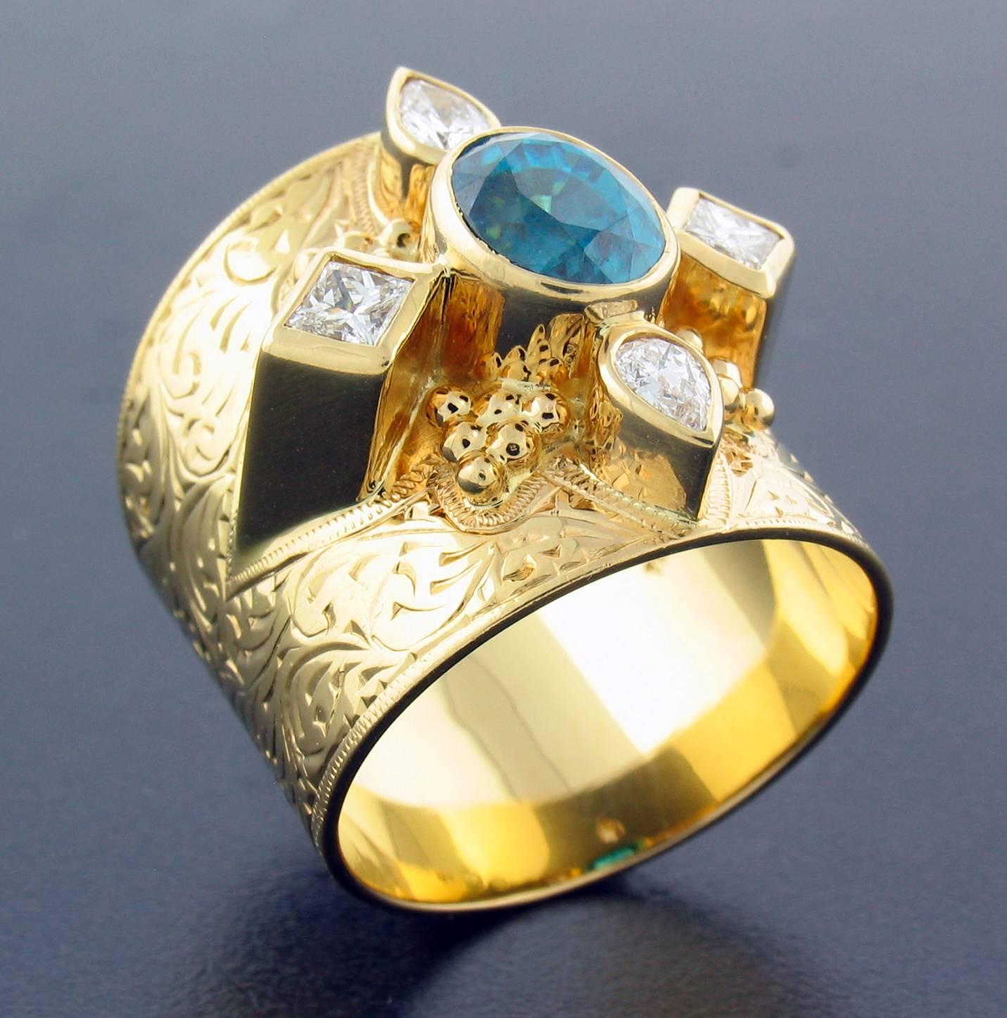 This ring was designed and made by well known designer Paula Crevoshay.  It contains a Natural Blue Zircon weighing 2.80 carats, and Diamonds weighing 0.52 carats.  It is made entirely in 18k yellow gold  The size is approximately a 7 1/2 ~ 8.  Wide