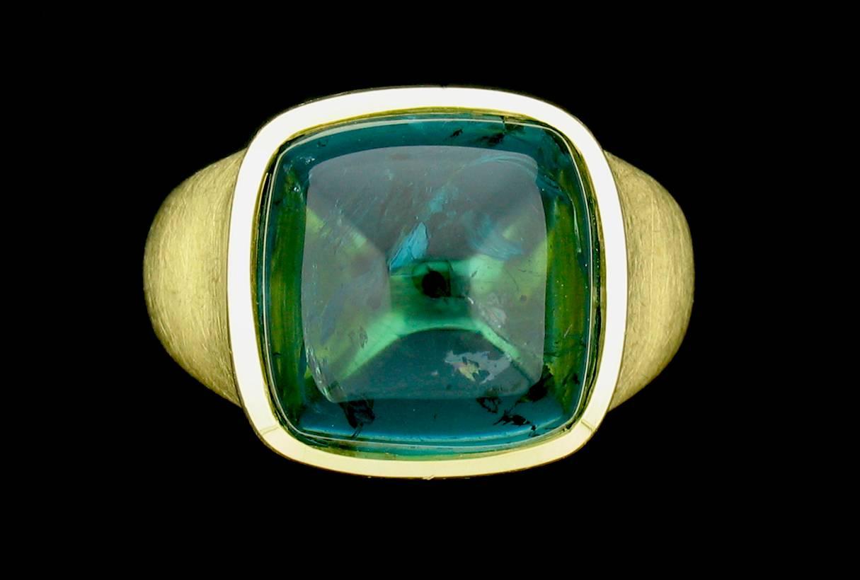 This ring features a fabulous 16.87 carat Blue-Green Tourmaline in a sugarloaf cut.  The setting is a brushed gold.  Size 7.  This is a slae item.  Regular price $16,600
