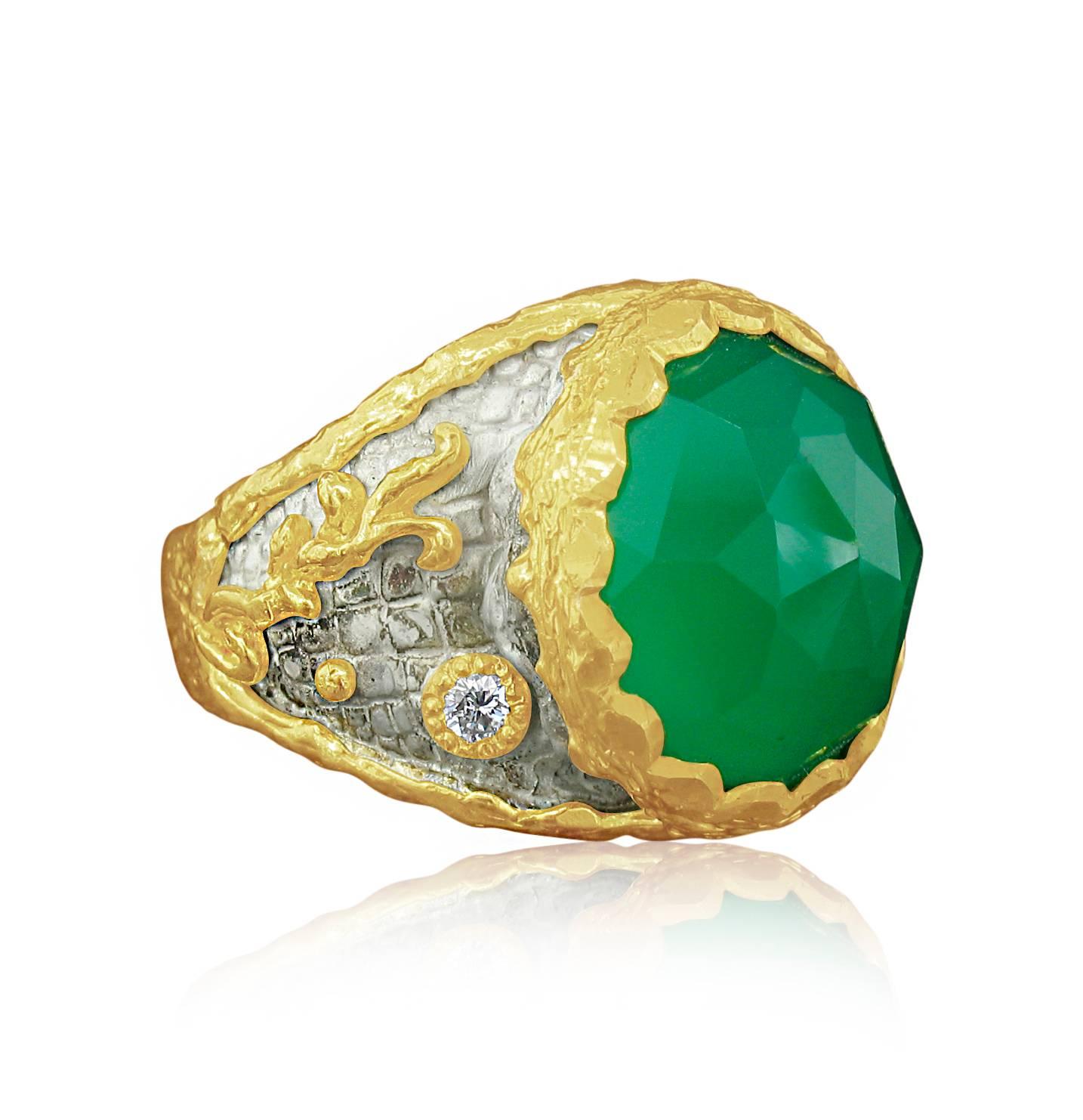 This ring was designed and made by well known designer Victor Velyan. It contains a brilliantly colored, slightly oval Green Onyx weighing 6.53 carats, and Diamond accents weighing 0.11 carats. The Green Onyx is reverse set to reveal the faceting. 