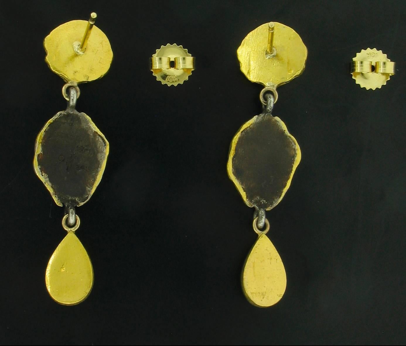 These Earrings were designed and made by well known designer Victor Velyan.   They contain 2 Peridots weighing 3.80 carats, two White Sapphires weighing 0.20 carats, and two little Pearls.  The earrings are made of a base of pure Silver with all