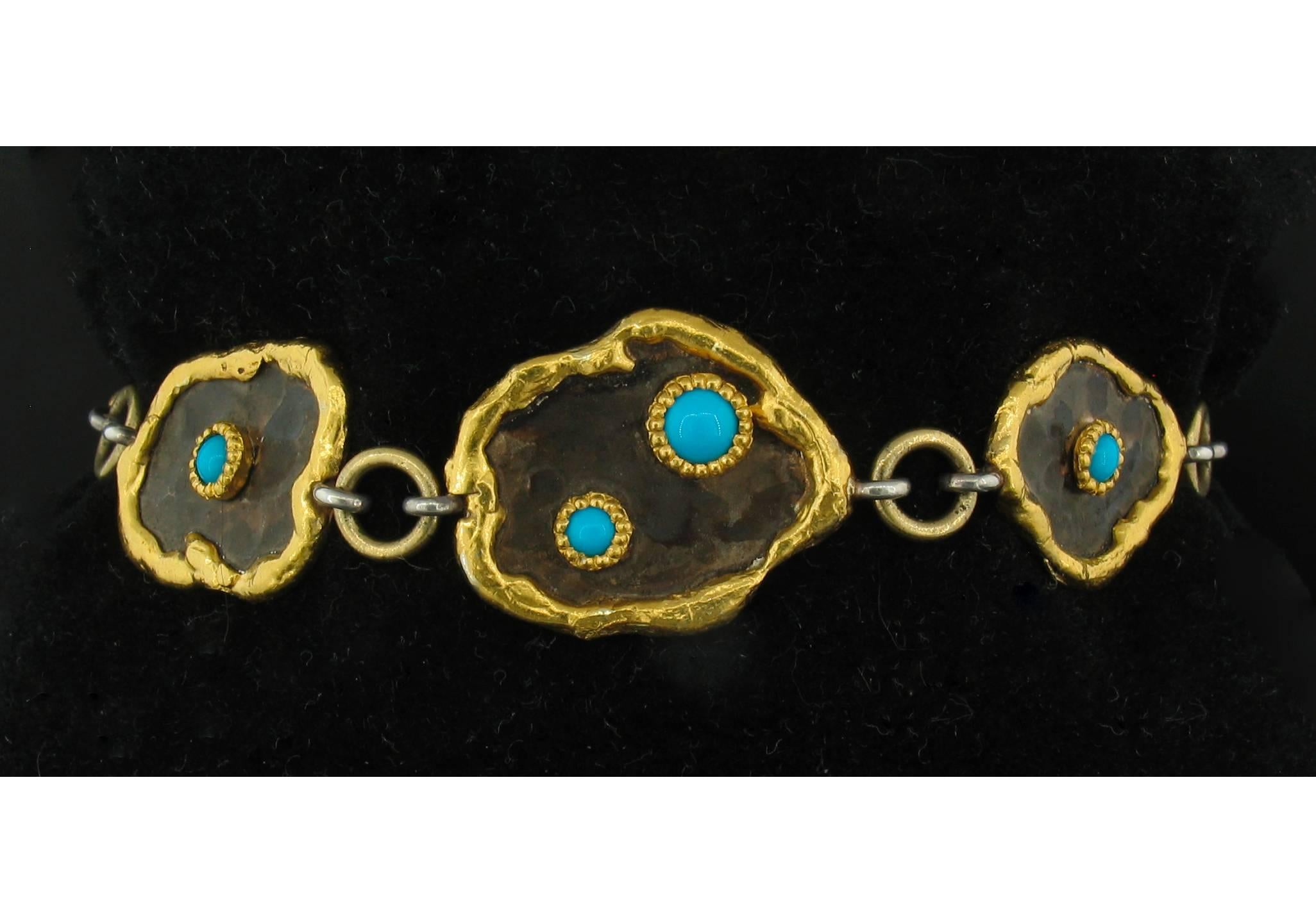 This Turquoise Link Bracelet was designed and made by well known designer Victor Velyan.  It contains 10 Turquoise cabochons weighing a total of 4.50 carats and are set in 24k gold and Silver.  The 'brown' is a proprietary patina hand painted and