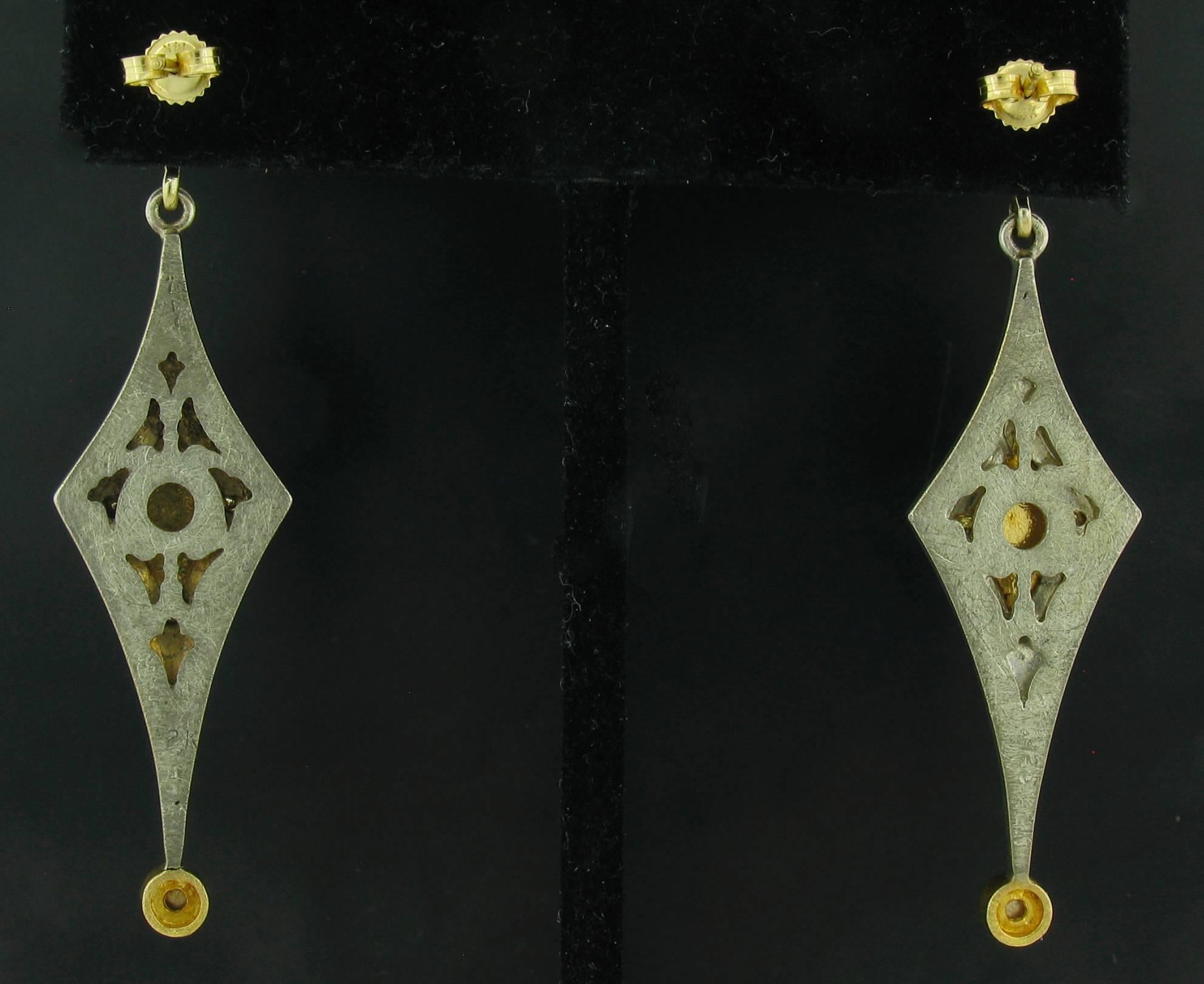 These Earrings were designed and made by well known designer Victor Velyan.  They contain 2 faceted, round Peridots weighing 1.78 carats, and Rosecut and Pave Diamonds weighing a total of 1.17 carats.  They are made of a base of Silver with all