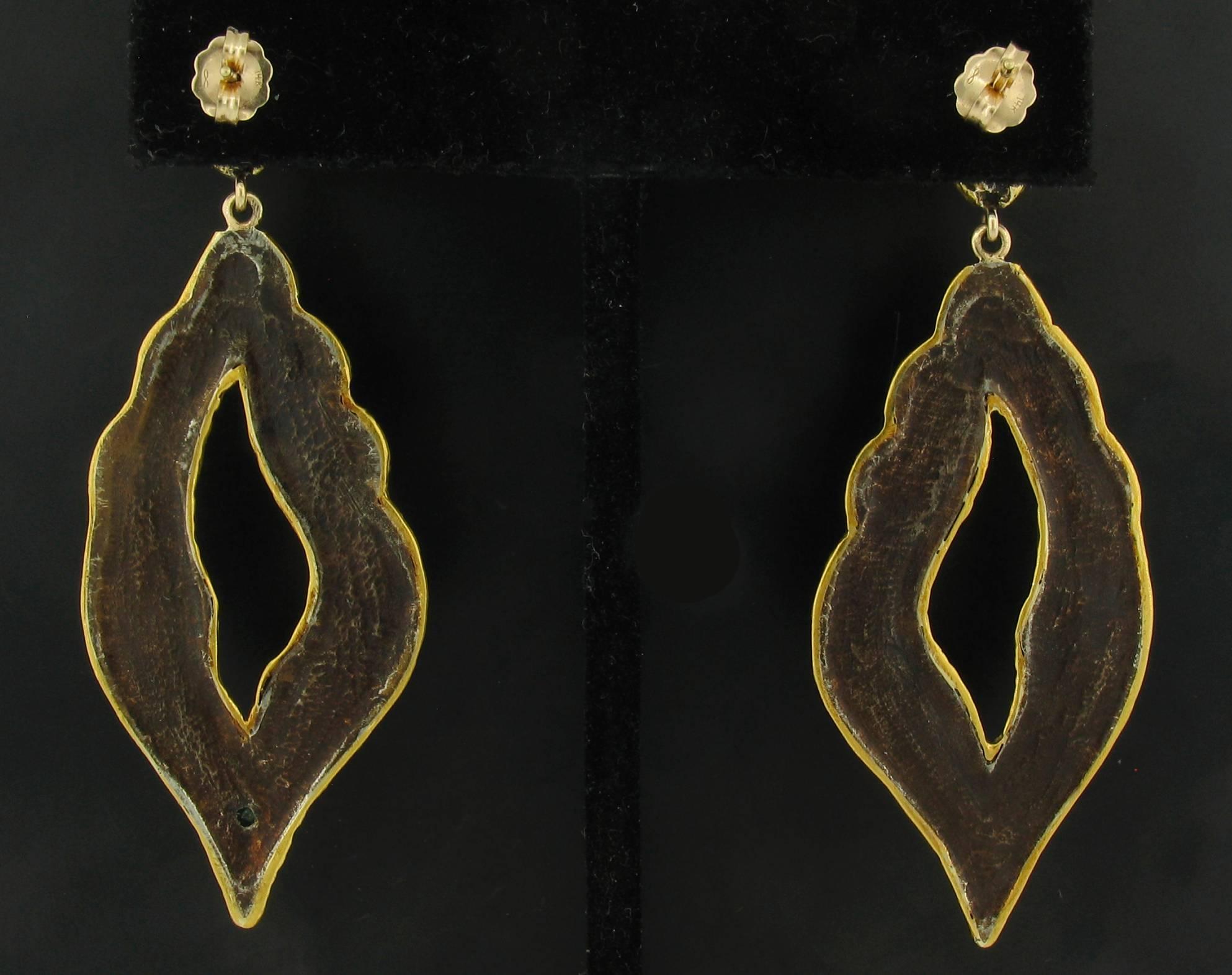 These Earrings were designed and made by well known designer Victor Velyan.   They contain 10 Beautiful Faceted Emeralds weighing 0.65 carats.  They are made of a base of pure Silver with all accent work created in 24k yellow Gold.  The 'brown' is a