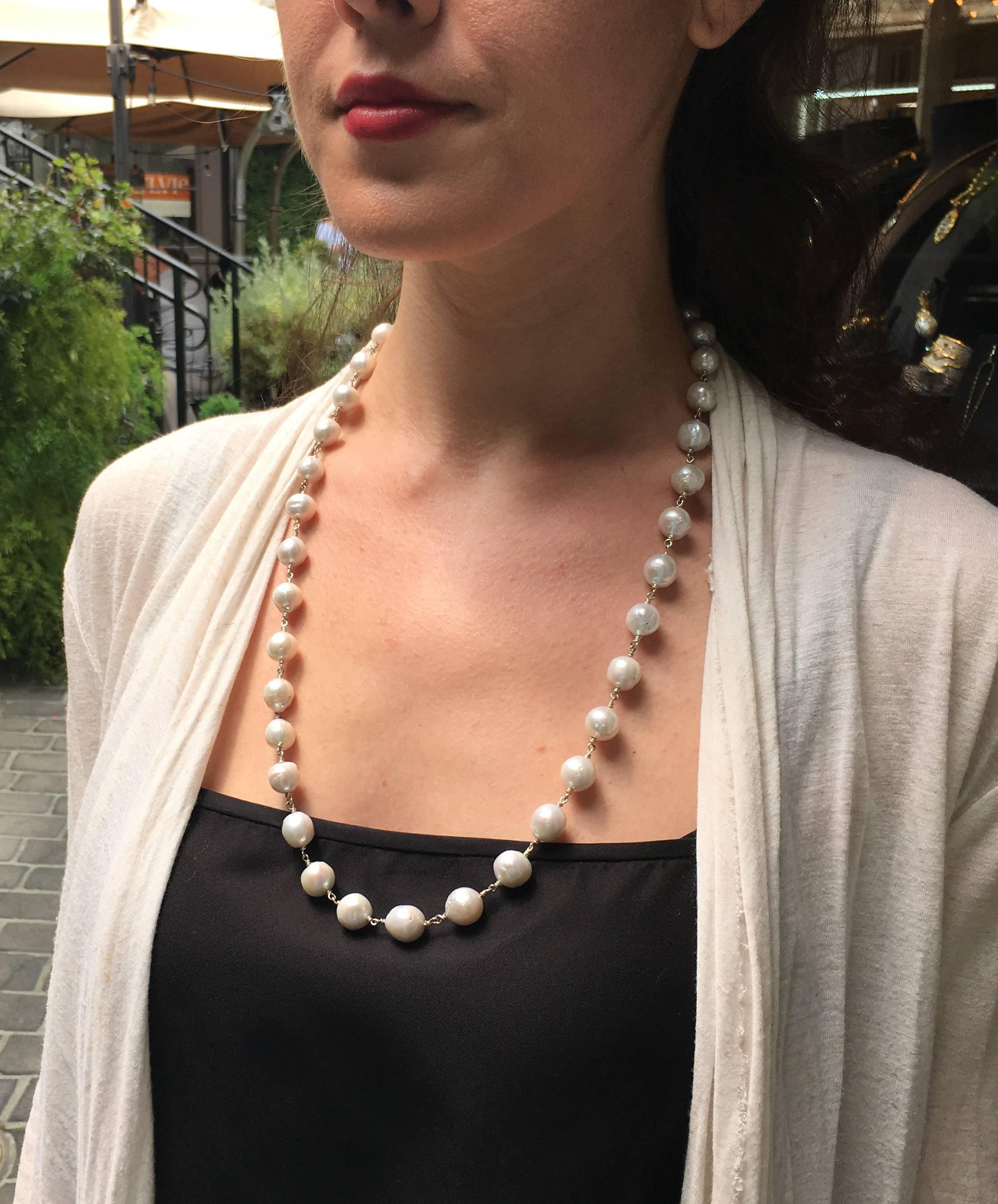 Lovely pearl necklace, 26" long with a sterling clasp.
Wire wrapping details between pearls are all silver.
Designed by Cayen Collection