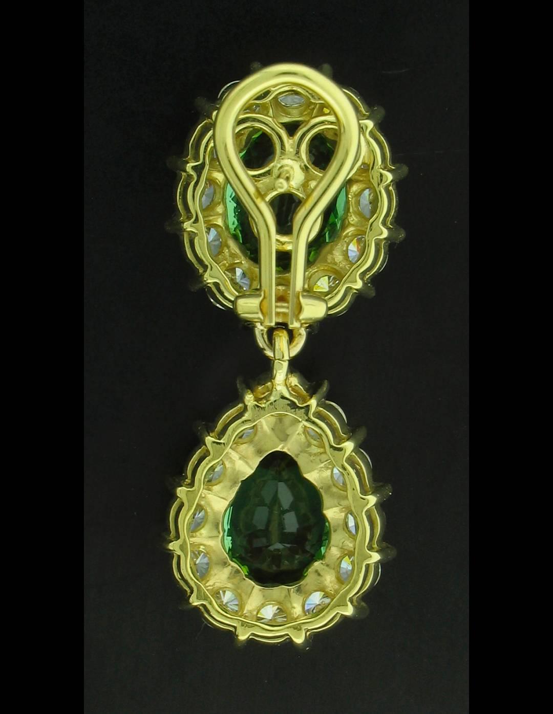 Two Oval and Two Pear Shaped Green Tourmalines weighing a total of  15.50 carats are surrounded by Diamonds F~G in color and S1 in clarity weigh 3.37 carats total.  18k yellow gold settings.  No hallmarks.  Post backs with Omega clips.  Matching
