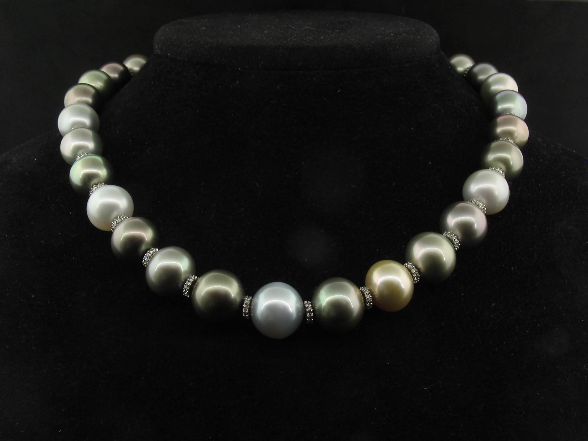 This lovely necklace combines 31 Tahitian South Sea pearls with Diamond rondelles of 18k white gold. The white gold clasp is also accented in Diamonds.  They graduate in size from 12.2mm to 14.9mm and the necklace measures 18 inches long.  Regular