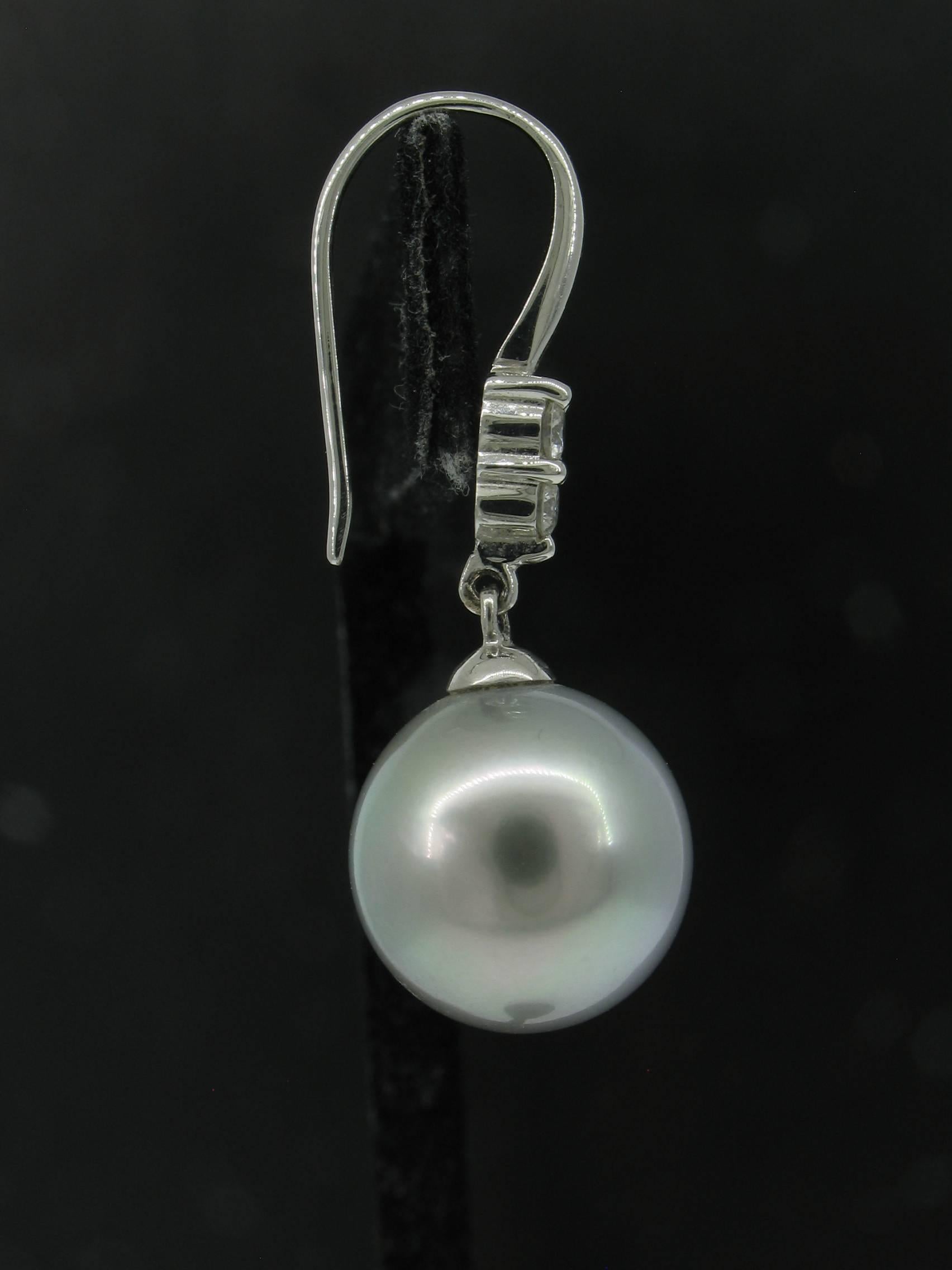 Tahitian Pearl Earrings hand crafted in Platinum with Diamonds weighing 0.22 carats total, E-F in color, VS in clarity.  Pearls are approximately 12.8mm x 12.9mm.  Shephard's Hook Posts.