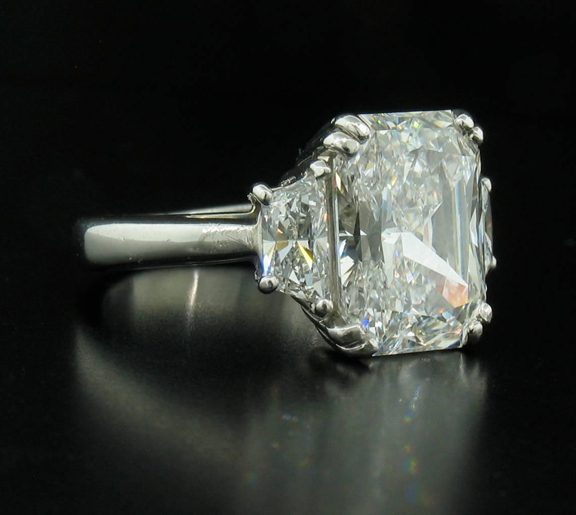 Stunning Diamond Ring with a 4.31ct Radiant center stone.  This is an ideal cut stone, hand selected by us.  It is an E - VS2 with a GIA laboratory report.  Two trapazoid Diamonds flank the sides of the center stone and weigh a total of 0.70cts. 