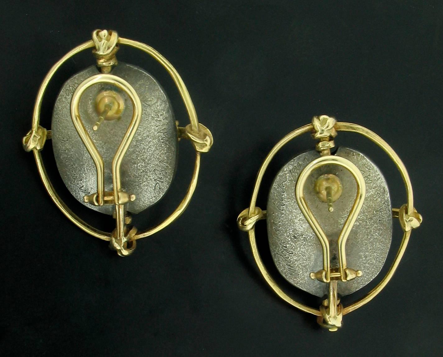 Original, hand made earrings by Designer Carolyn Morris Bach.  Beautiful Pearls approx 9mm in diameter are set in Carolyn's trademark gold and silver work.  These are set in 18k and Fine Silver.  Post backs with french clips.  Signed Carolyn Morris