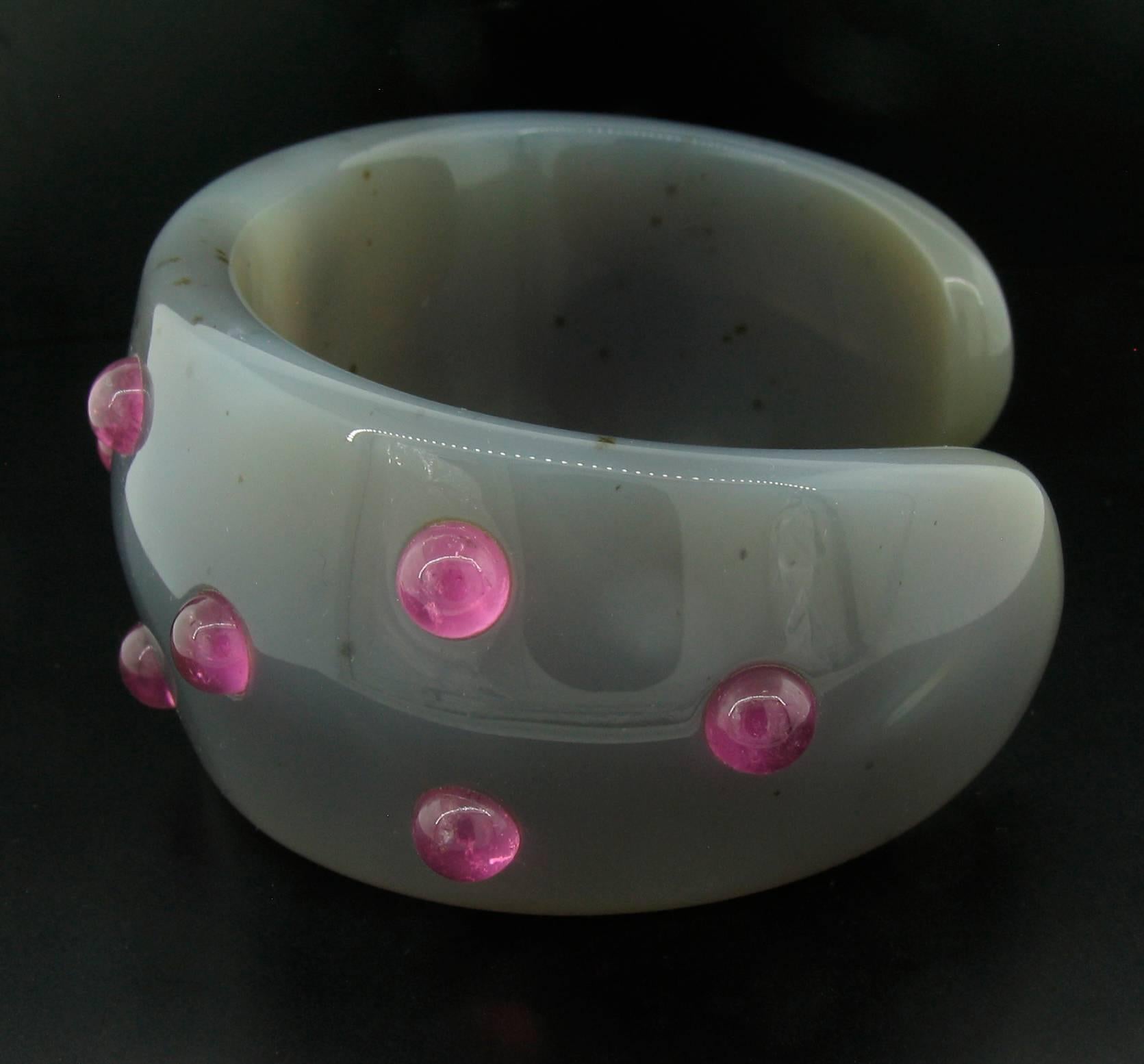 Lovely, carved grey agate cuff is dotted with cabochon Rubelite stones.  Extremely comfortable and a great fashion statement! 2 7/8