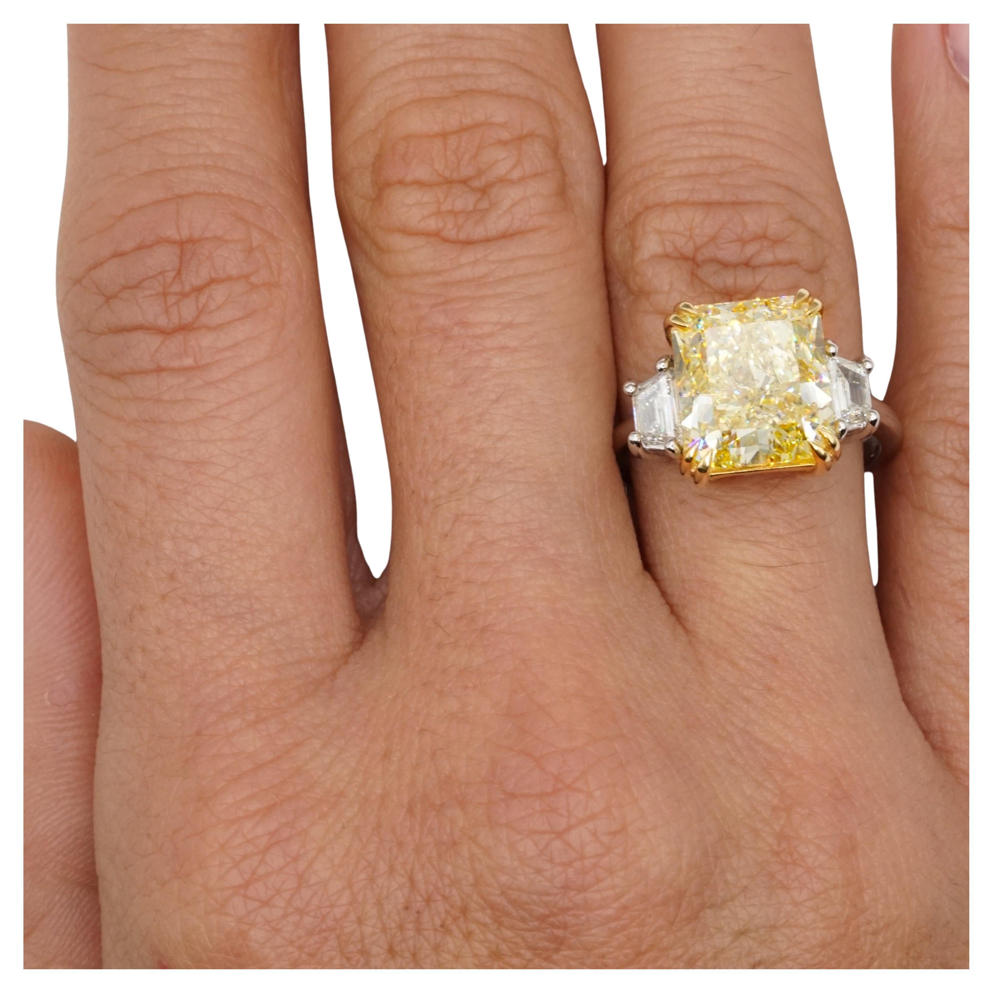 This extraordinary ring showcases a dazzling GIA-certified 8-carat radiant-cut Fancy Yellow diamond as its centerpiece. The diamond's vibrant color and exceptional brilliance are beautifully highlighted in an 18K yellow gold prong setting, allowing