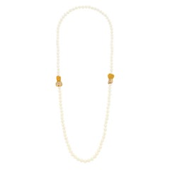 Collana "Filo di perle" di Van Cleef & Arpels con doppio cuore in zaffiro giallo e diamanti