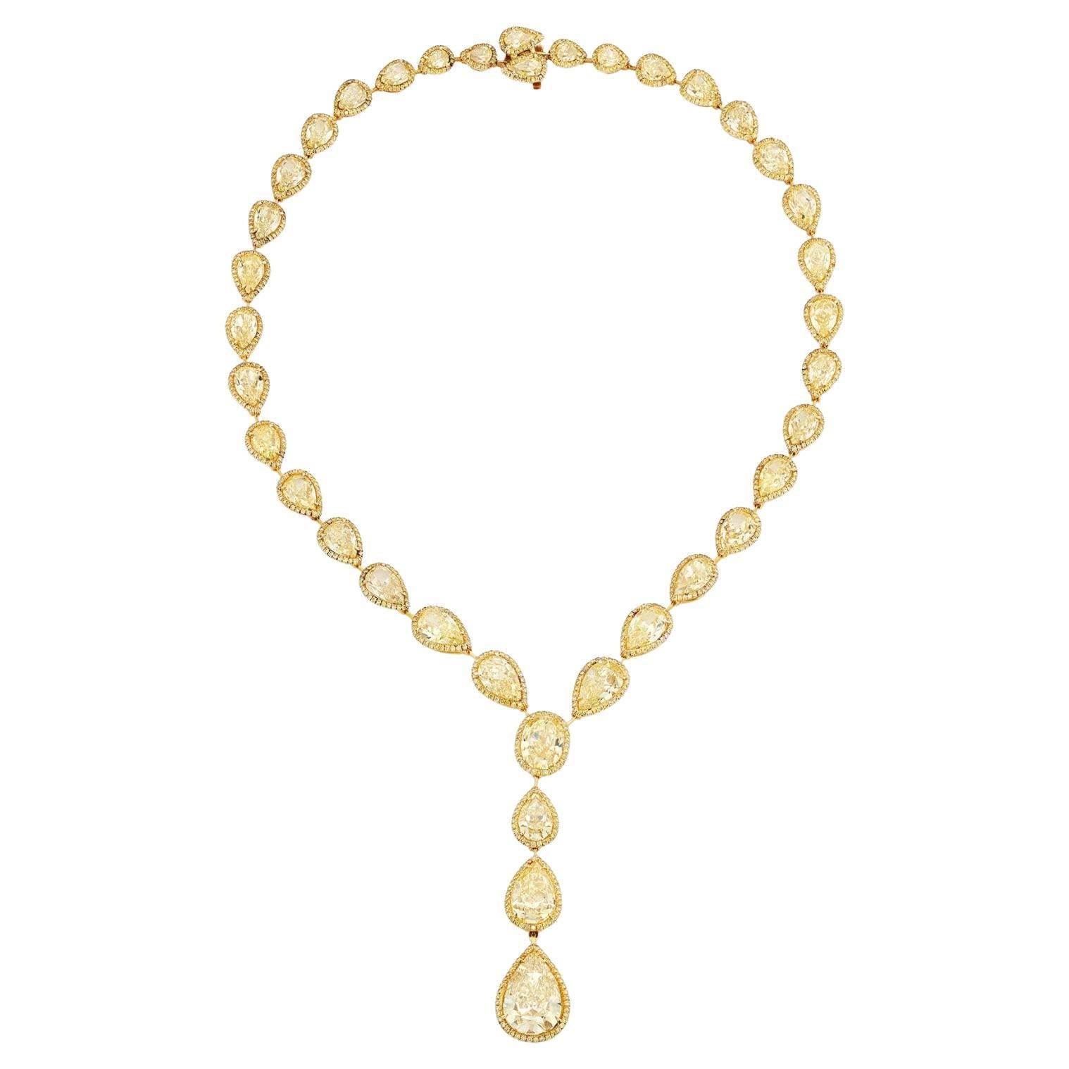This 80 Carat Fancy Yellow Diamond Necklace is a bold, regal expression of legacy — created for connoisseurs who recognize the power of scale, saturation, and pedigree. At its heart lies a 10+ carat Fancy Yellow diamond with commanding presence,