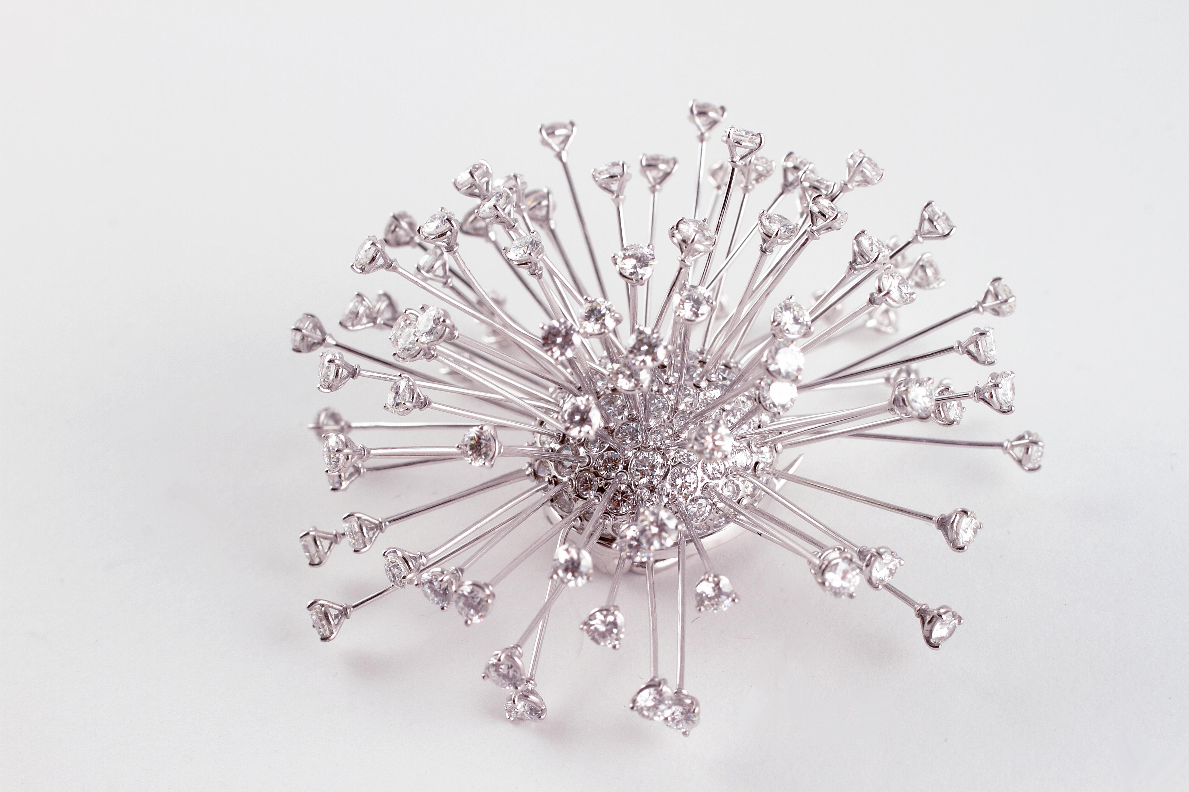 This elegant handcrafted brooch by famed London designer David Morris features 18 karat white gold en tremblant stalks that terminate in brilliant-cut diamonds, set into a center supporting additional diamonds.  The estimated total weight of all