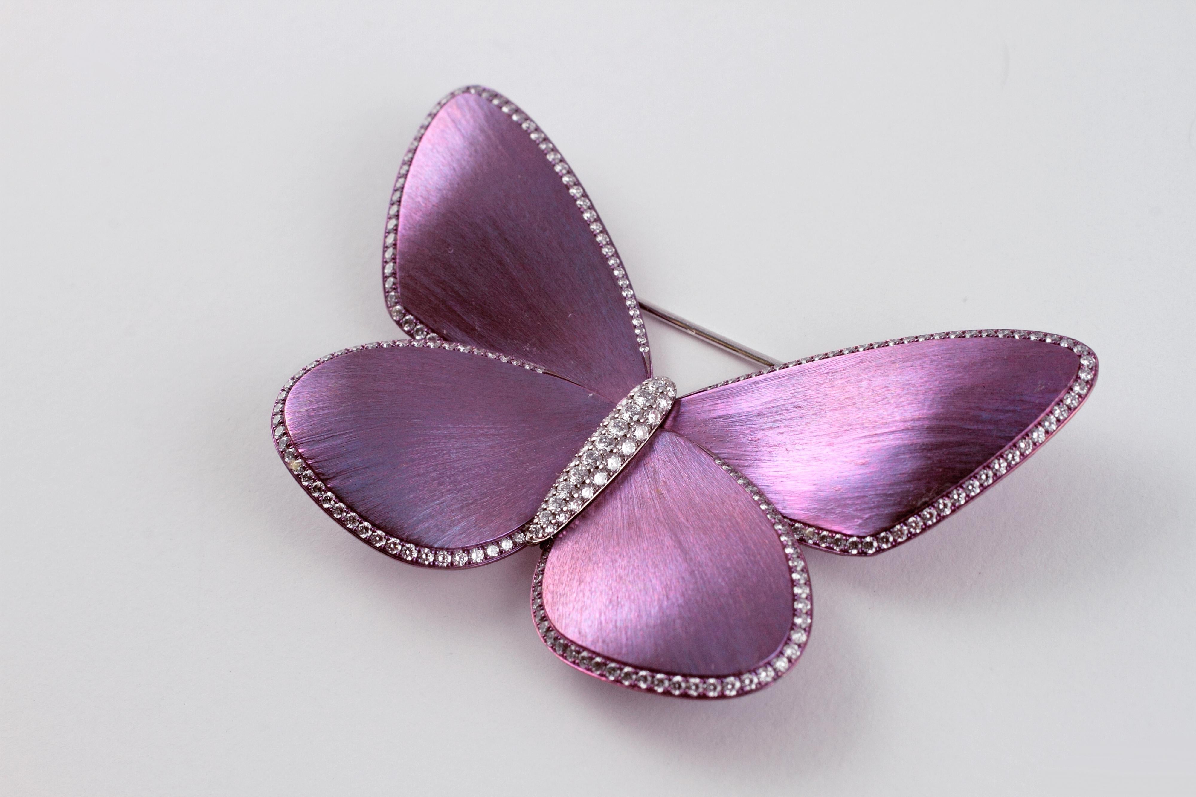 For the Eclat collector, or the first time buyer, this is truly an unusual item.  The lovely purplish titanium wings are accented by a diamond trim and diamond central body.  The Neiman Marcus receipt states that the diamonds are 1.31 carats in
