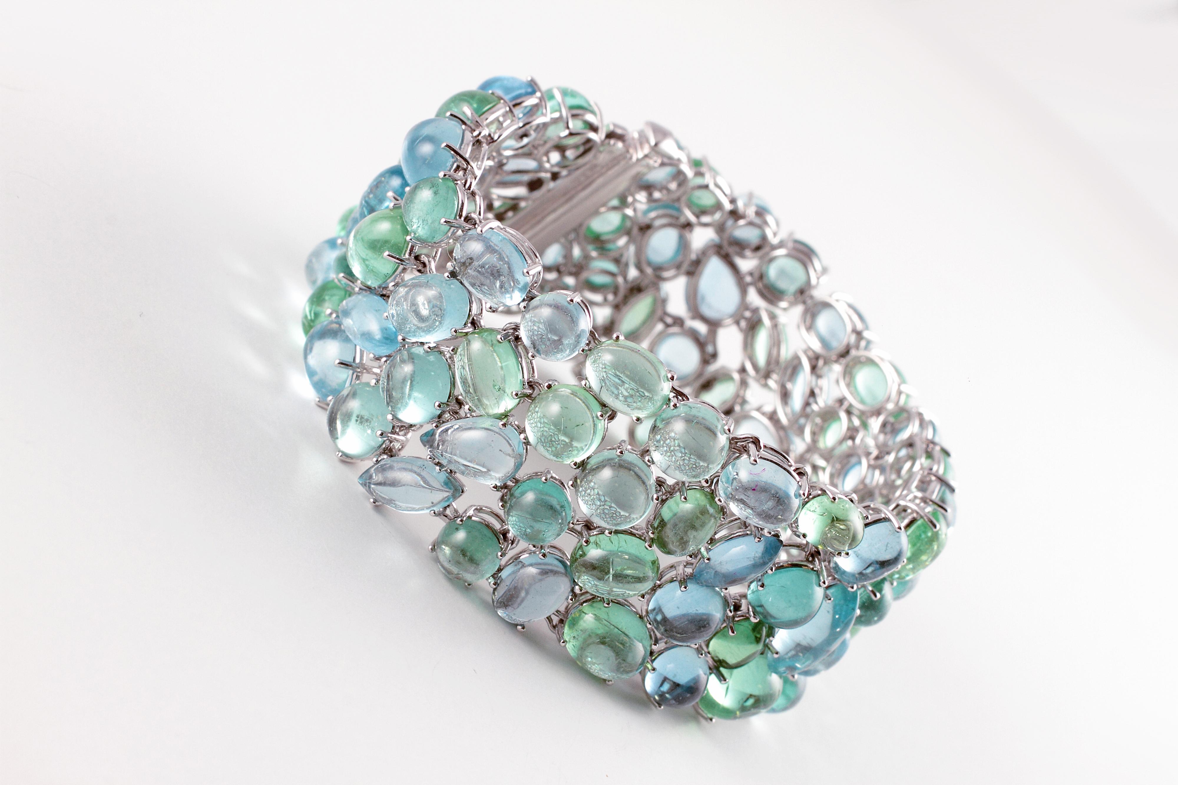 Don't you just love the soft greens and blues in this elegant bracelet by Robert Erich?  The oval-shaped cabochon-cut 52.35 carats of aquamarines complement the 65.13 carats of oval-shaped cabochon-cut tourmaline and the 0.65 cts of diamonds are