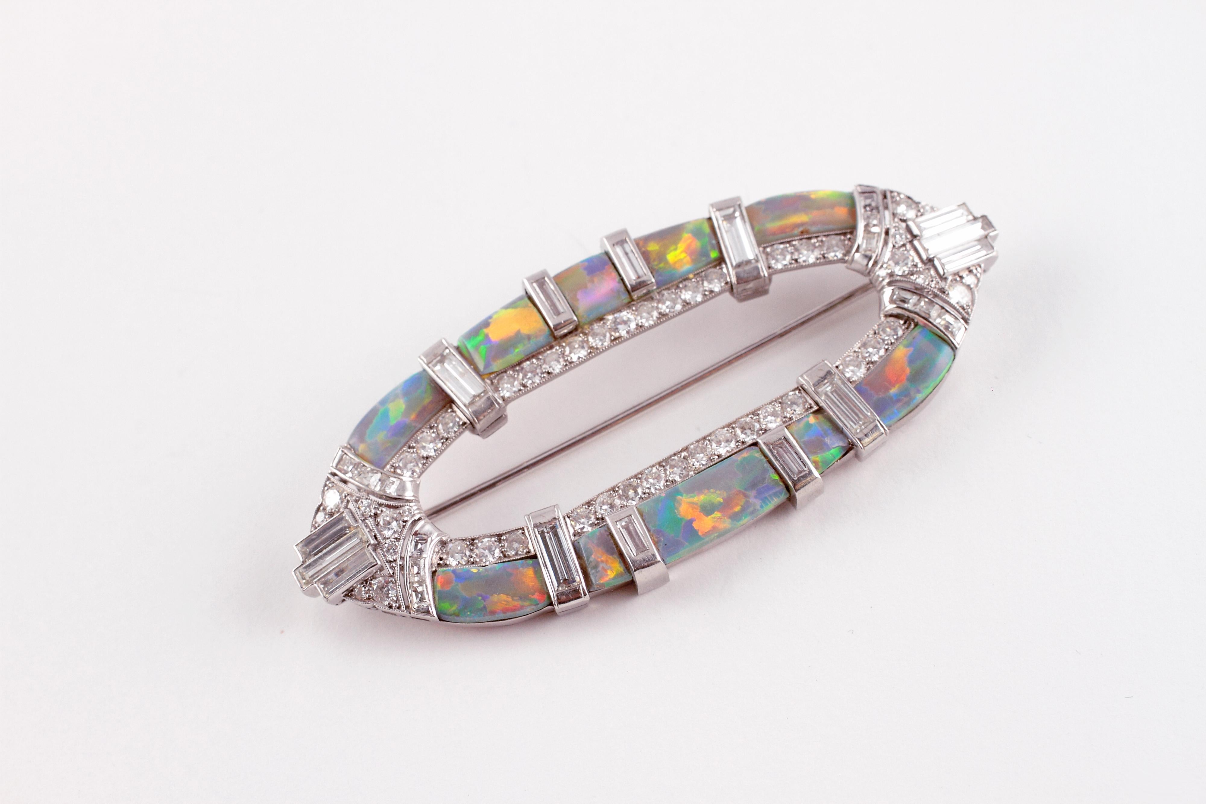 Such a lovely treasure from the past!  Composed of platinum and secured with a straight pin clasp, in an Art Deco style.  This beauty has sections of opal, alternating with diamonds.  The total stated diamond weight is approximately 4.65 cts and the