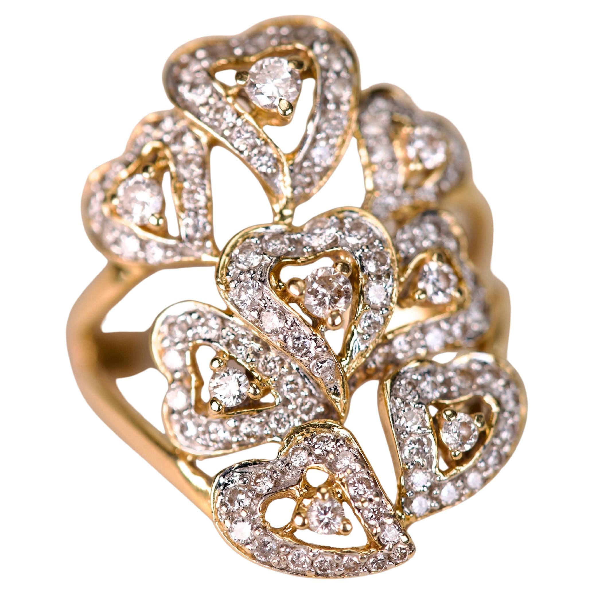 Cette bague en or jaune ornée d'environ 1,26 ct de diamants taille brillant est une déclaration captivante d'élégance et d'art. Le design présente un arrangement complexe de motifs de cœurs ajourés, chacun délicatement souligné de diamants sertis en